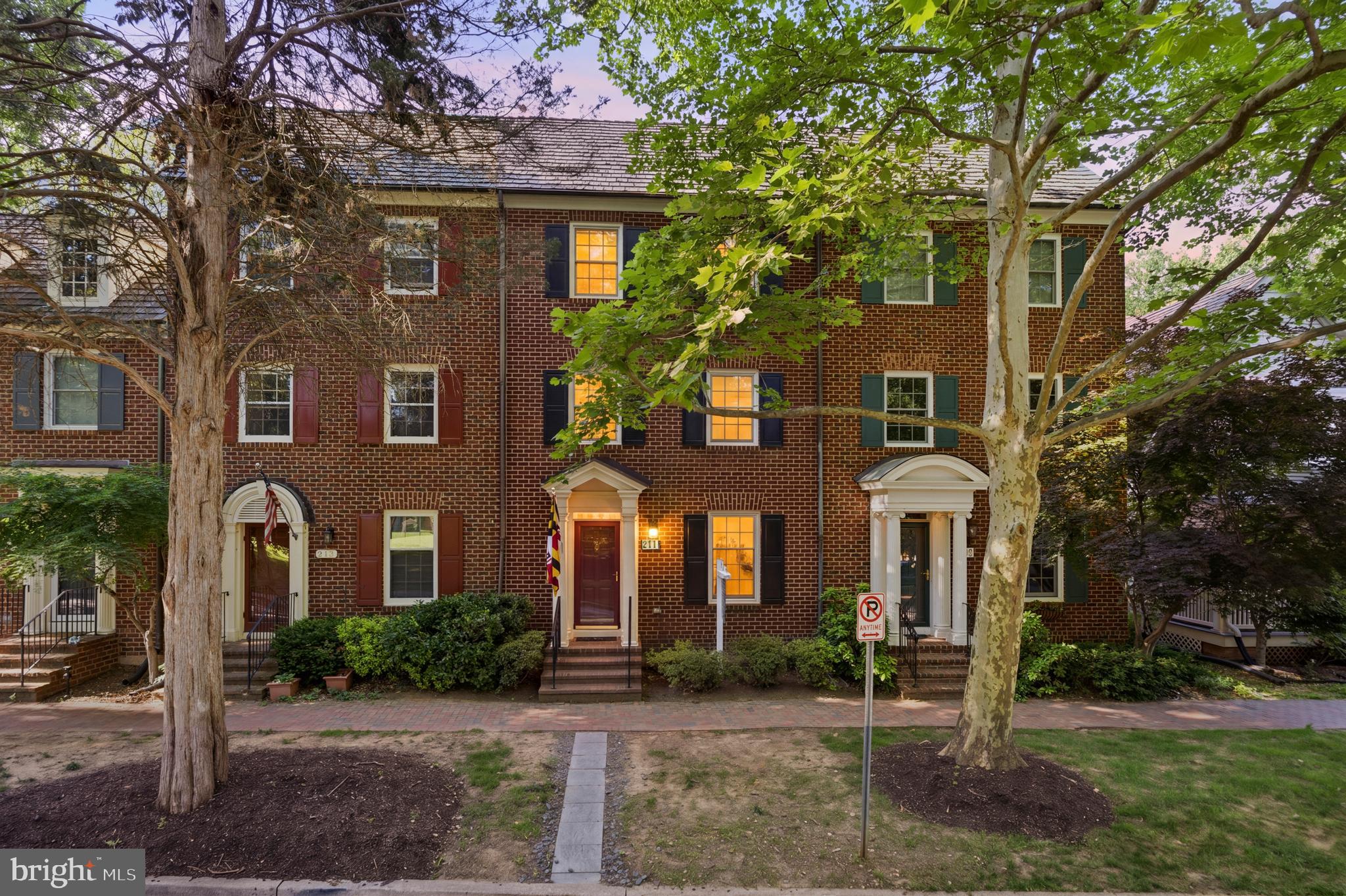 A Chef's Kitchen, Four Levels of Living, and the Best of Kentlands at Your Door.

Tucked into one of Gaithersburg's most beloved walkable neighborhoods, this stately townhome pairs classic brick charm with thoughtful interior renovations across four levels and nearly 2,900 finished square feet. Set on a tree-lined street with a covered portico entry, it offers three large bedrooms, a versatile den, and 4.5 baths — plus freshly painted interiors, newer hardwood floors, and fresh carpet throughout for a true move-in-ready feel.

The showstopper is the chef's kitchen, fully reimagined with navy shaker cabinetry, brass hardware, quartz countertops, a farmhouse sink, a vented stainless range hood, and timeless white subway tile — plus a peninsula breakfast bar with seating for casual meals and morning coffee. A generous walk-in pantry with custom built-ins keeps everything in its place, and sliding glass doors open to a private fenced backyard with a flagstone patio, lawn, and lush ivy-covered walls — a rare outdoor retreat just steps from the kitchen. Open to the kitchen, an elegant dining area is defined by custom arched built-ins, chair-rail trim, and crown molding — a natural gathering spot with easy flow to the backyard.

The main level continues with a bright, open layout anchored by a cozy fireplace with an elegant mantel and custom tile surround, where crown molding, recessed lighting, and freshly painted ivory walls keep the space warm and airy and a large picture window frames leafy, wooded views. 

Upstairs, the spacious primary suite is bright and restful — with two closets, a ceiling fan, and two large windows overlooking the trees. The ensuite bath features a marble double-vanity and a frameless glass shower. The adjoining den — bright, sunny, and flexible, with a large window — makes a beautiful home office, nursery, or guest space. The fourth level holds two more well-sized bedrooms, each with its own full bath and views of the surrounding park and treetops.

Downstairs, the fully finished lower level adds a flexible recreation room — easily a playroom, home gym, or media space — along with a full bath and full-size laundry, rounding out the home's everyday livability. A two car garage and ample guest parking completes the package.

Set in the Kentlands Old Farm community, you're moments from Main Street shops and restaurants, Whole Foods, the Arts Barn, the Kentlands Mansion, Lakes, Parks, and top-rated Montgomery County schools. 

Turn-key, move-in-ready, and full of character — this one checks every box.
