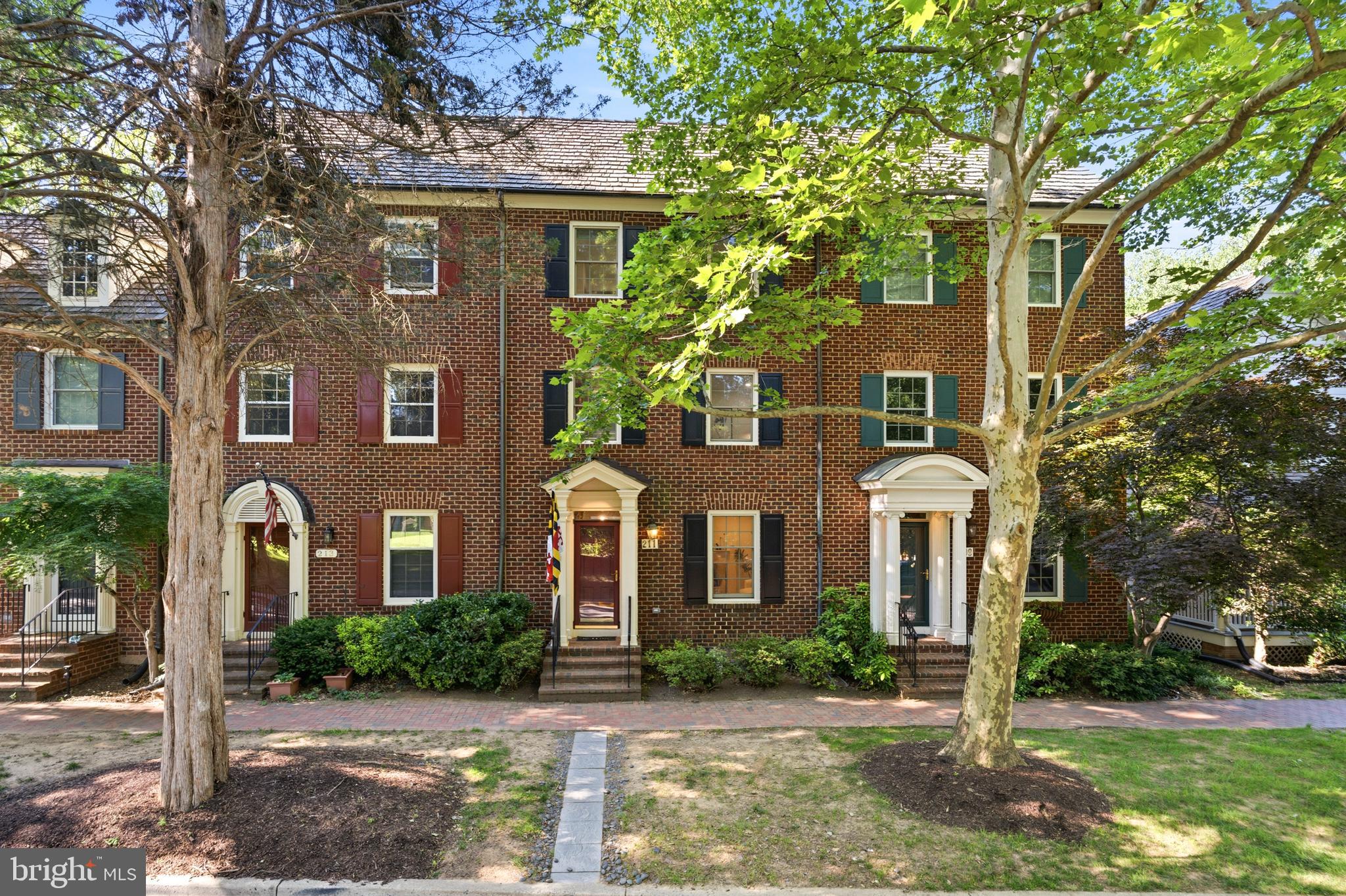 OPEN HOUSE SUNDAY FROM 1PM-3PM

A Chef's Kitchen, Four Levels of Living, and the Best of Kentlands at Your Door.

Tucked into one of Gaithersburg's most beloved walkable neighborhoods, this stately townhome pairs classic brick charm with thoughtful interior renovations across four levels and nearly 2,900 finished square feet. Set on a tree-lined street with a covered portico entry, it offers three large bedrooms, a versatile den, and 4.5 baths — plus freshly painted interiors, newer hardwood floors, and fresh carpet throughout for a true move-in-ready feel.

The showstopper is the chef's kitchen, fully reimagined with navy shaker cabinetry, brass hardware, quartz countertops, a farmhouse sink, a vented stainless range hood, and timeless white subway tile — plus a peninsula breakfast bar with seating for casual meals and morning coffee. A generous walk-in pantry with custom built-ins keeps everything in its place, and sliding glass doors open to a private fenced backyard with a flagstone patio, lawn, and lush ivy-covered walls — a rare outdoor retreat just steps from the kitchen. Open to the kitchen, an elegant dining area is defined by custom arched built-ins, chair-rail trim, and crown molding — a natural gathering spot with easy flow to the backyard.

The main level continues with a bright, open layout anchored by a cozy fireplace with an elegant mantel and custom tile surround, where crown molding, recessed lighting, and freshly painted ivory walls keep the space warm and airy and a large picture window frames leafy, wooded views. 

Upstairs, the spacious primary suite is bright and restful — with two closets, a ceiling fan, and two large windows overlooking the trees. The ensuite bath features a marble double-vanity and a frameless glass shower. The adjoining den — bright, sunny, and flexible, with a large window — makes a beautiful home office, nursery, or guest space. The fourth level holds two more well-sized bedrooms, each with its own full bath and views of the surrounding park and treetops.

Downstairs, the fully finished lower level adds a flexible recreation room — easily a playroom, home gym, or media space — along with a full bath and full-size laundry, rounding out the home's everyday livability. A two car garage and ample guest parking completes the package.

Set in the Kentlands Old Farm community, you're moments from Main Street shops and restaurants, Whole Foods, the Arts Barn, the Kentlands Mansion, Lakes, Parks, and top-rated Montgomery County schools. 

Turn-key, move-in-ready, and full of character — this one checks every box.