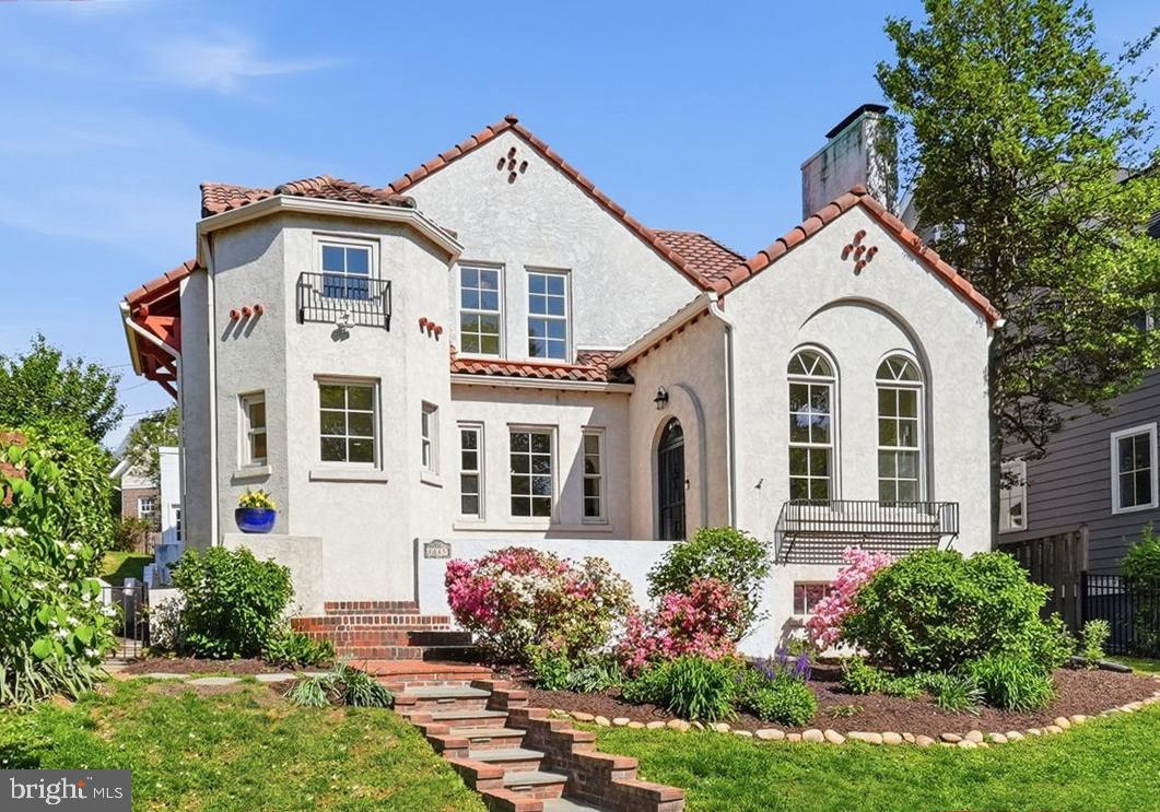 A Lyon Village Gem!
Step into the charm and character of this beautifully preserved 1929 Spanish Bungalow, offering 5 bedrooms, 4.5 baths, and just under 3,900 square feet of inviting living space. Rich in architectural detail, the home showcases classic white stucco walls, a red terracotta tile roof, graceful arched doorways, and elegant ornamental ironwork throughout creating a warm, timeless ambiance from the moment you arrive.
Inside, exquisite craftsmanship shines alongside thoughtful updates. The welcoming living room features soaring 11.5-foot ceilings, dramatic Palladian windows, and a stunning kiva-style fireplace while a gracious formal dining room sets the stage for memorable gatherings. The cozy family room—with custom built-ins—opens through French doors to a private patio, perfect for effortless indoor-outdoor living.
At the heart of the home, the spacious kitchen offers top of the line appliances an expansive island, abundant storage, a pantry, and a charming breakfast area framed by a bay window and arched entry. 
The main level is completed with two bedrooms—one ensuite—providing flexible living options, and a stylish powder room.
Upstairs, a serene primary suite, which boasts a fireplace, walk-in closet and a spa-inspired bath with soaking tub, glass-enclosed shower, and double vanity. Two additional bedrooms, one with a delightful window seat share a Jack-and-Jill bath, along with a whimsical hidden playroom featuring custom built-ins. A conveniently located laundry room completes the upper level. Additional highlights include hardwood floors, new carpeting in select bedrooms, a terracotta-tiled lower level with abundant storage, and a two-car garage.
Outside, enjoy private, shaded outdoor living spaces surrounded by mature landscaping and a fully fenced yard—ideal for relaxing or entertaining. 
Perfectly positioned across from the Lyon Village playground, just blocks to the heart of Clarendon with shops, dining, gyms and Metro, this home offers a rare blend of historic charm, modern comfort, and an unbeatable location.  ***OFFERS DUE MONDAY, 5/4 at 5pm.***