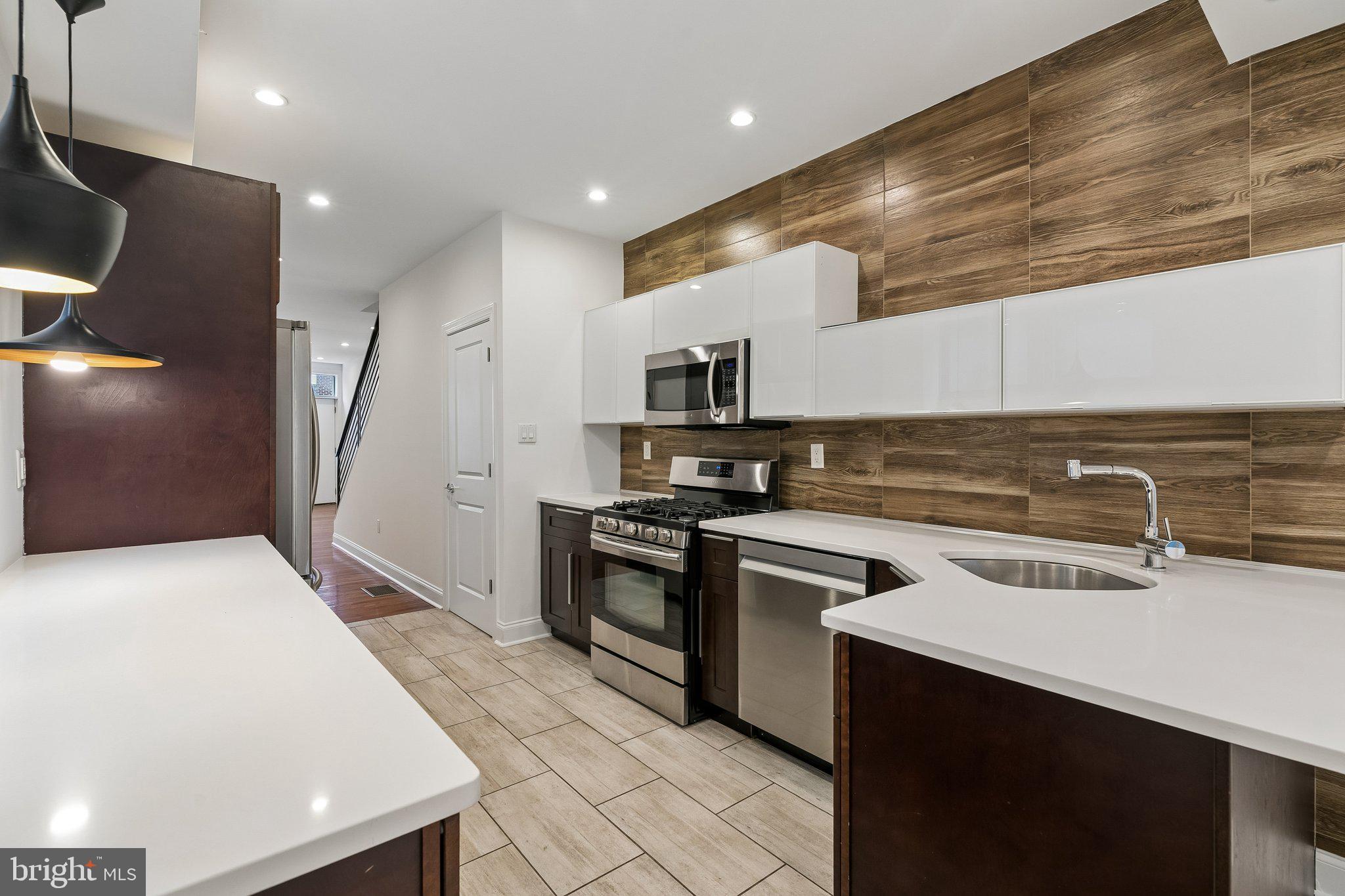Welcome to 1818 S. 4th Street, a meticulously maintained 3-bedroom, 2.5-bath townhouse tucked away on one of Pennsport's quietest and most desirable blocks. Perfectly positioned just one block from public transportation, you'll enjoy easy access to the city while benefiting from the peaceful atmosphere of a low-traffic residential street.

From the moment you enter, you'll notice how exceptionally well cared for this home has been. Natural light pours into the living spaces throughout the day, including the kitchen, which benefits from a rare side exposure created by the space between neighboring buildings.

The spacious main level offers an inviting flow for both everyday living and entertaining. The kitchen features ample cabinetry, quartz countertops, and recently updated appliances. Whether you're hosting friends for dinner, gathering with family, or enjoying a quiet evening at home, the layout provides the perfect backdrop.

Upstairs, the primary suite offers a comfortable retreat with a private bath. Two additional bedrooms provide flexibility and can easily serve as guest rooms, a nursery, home offices, fitness space, or creative studios depending on your needs. The large basement also provides abundant storage space.

Outdoor living is where this home truly shines. Step out to the private rear patio, ideal for grilling, dining al fresco, or enjoying your morning coffee. Above, the expansive roof deck serves as an urban escape. Unlike many city roof decks, this space offers a remarkable sense of privacy with fewer neighboring decks overlooking the area.

Location is everything, and this home delivers. Dickinson Square Park is just a few blocks away, offering green space, a popular playground, community events, and room to enjoy the outdoors. Pennsport's vibrant dining and café scene is right outside your door, with neighborhood favorites all within walking distance. Everyday conveniences are equally accessible, including Target, IKEA, Lowe's, Acme, and countless shops and services. This location makes car-free living not only possible but enjoyable.

Combining thoughtful updates, exceptional outdoor space, abundant natural light, generous storage, and one of South Philadelphia's most walkable locations, this move-in-ready Pennsport home offers the perfect balance of comfort, convenience, and city living.
