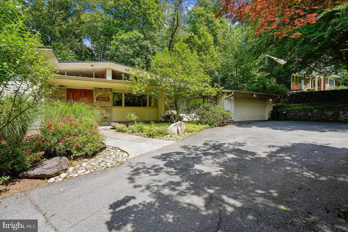 Timeless mid-century modern design meets exceptional opportunity in sought-after Burning Tree Manor. Set on a beautifully landscaped lot in one of Bethesda’s most desirable neighborhoods, this spacious residence offers a thoughtfully designed floor plan with five bedrooms and 3.5 bathrooms across a main level and fully finished lower level.

The light-filled interior showcases the clean lines and open flow that define mid-century architecture, anchored by a renovated kitchen that seamlessly connects to the home’s generous living and dining spaces. Expansive windows invite the outdoors in, while a large deck and slate patio provide ideal settings for entertaining, al fresco dining, or simply enjoying the peaceful surroundings. A two-car garage adds everyday convenience.

Lovingly maintained and highly livable as-is, the home also presents an exceptional opportunity for those looking to personalize and elevate a classic property in a premier location. Nestled within the coveted Burning Tree Manor community—known for its established streetscapes, proximity to downtown Bethesda, desirable schools (Seven Locks/Cabin John/Churchill High School), and easy commuter access—this is a rare chance to create your vision in an highly sought-after setting.