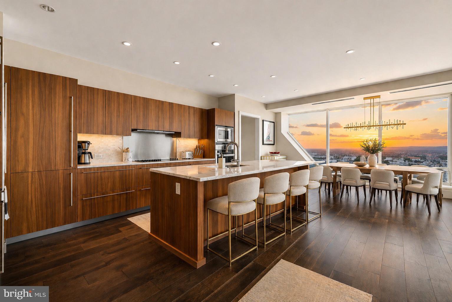 Introducing a refined opportunity at The Residences at Two Liberty, perched on the 55th floor as part of the exclusive Penthouse Collection, the top five floors of the building. This exceptional 2,425-square-foot, 3-bedroom, 3.5-bath home offers a thoughtfully designed layout with dramatic city skyline exposures and a front-row seat to Fourth of July fireworks, Phillies and Eagles celebrations, the Mummers Day Parade and City Hall.

A gracious entry foyer leads into a sleek gourmet kitchen outfitted with Calacatta marble, Miele and Sub-Zero appliances, opening seamlessly to an expansive living and dining space framed by floor-to-ceiling windows showcasing sweeping panoramic views of both the Schuylkill and Delaware Rivers, and anchored by a remote gas fireplace with custom mantel, ideal for both entertaining and everyday living. Morning sunrises and evening sunsets frame the views in every direction, offering a perspective few will ever experience. Designer touches include Phillip Jeffries wallcoverings and custom California Closets throughout, maximizing storage while elevating every room. A dedicated storage unit conveys with the residence. Twelve-to-fifteen-inch concrete walls and extra-thick installation deliver exceptional peace, you won't hear a pin drop, and with only four residences on the floor, privacy is unmatched.

Two private garage parking spaces with valet service are included (inquire with listing agent for fee details), along with discounted 12-, 24-, and 48-hour passes for guests and a full-detail car wash on site. Parking may be leased on a flexible month-to-month basis and is not required to be secured for a full year, offering added convenience for those who travel frequently or do not need the space(s) year-round. Centrally located in the heart of Center City Rittenhouse neighborhood, the home offers indoor access to the shops at Liberty Place. Minutes from Rittenhouse Square, renowned dining, luxury retail, luxurious spas and cultural destinations. 30th Street Station is less than 10 minutes away for easy access to New York (approximately 90 minutes), 20 minutes to the Main Line surrounding suburbs, and the Jersey Shore is roughly an hour by car for effortless weekend escapes.

The newly renovated amenities floor, completed in 2024, includes an extensive fitness center, indoor pool, yoga studio, spa with private massage rooms, sauna and steam rooms, caterer’s kitchen, billiards room, media lounge, two conference rooms, and a business center, plus a gorgeous resident lounge that hosts the 2Lib book club, cocktail hours, mahjong, and Eagles watch parties. White-glove services include 24-hour concierge (happy to accept DoorDash deliveries or drop items such as dry cleaning inside your home), complimentary house car service, and a chauffeur-driven Mercedes town car. The building is also happy to accommodate large parties or catered events in your residence or on the amenities floor. Pet-friendly and turnkey, this residence delivers a sophisticated lifestyle at one of Philadelphia’s most sought-after addresses.
