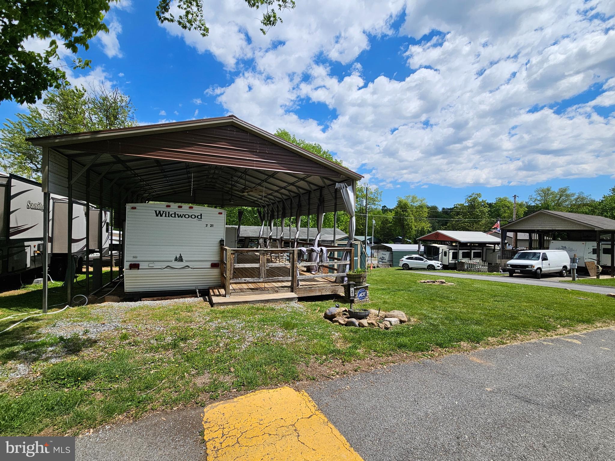 Impressively Large Corner Lot! Sitting on the corner of Campfire and Yogi Bear so no neighbors piled on top leaves plenty of room for parking or yard activities. Campfires, or cornhole whatever your heart desires. This lot features a large metal pavilion sitting on concrete posts, covering a 12*40 wooded deck, housing a 2005 40Ft Forrest River Wildwood Camper. Inside you'll find a Queen size bed on one end and a bunk room on the other with a set of twin bunkbeds. Some of the upgrades include a newer instant hot water heater, porcelain toilet, refrigerator, 2 electric massage chair recliners and a wooded table with bench seating and storage.  The camper has dual entry and a sliding glass door right to your porch to enjoy your coffee and listen to nature or take in the view of the Potomac River that is one block away. The Pavilion has curtains that snap together and looped to a wire so the wind can't blow them all over the place. Outside also has 3 ceiling fans with lights w/ remote to keep that warm summer breeze a flowing. There is an extra standard size refrigerator outside as well as a microwave tucked in the custom build cabinet. Everything you see conveys, all the patio furniture, shed, self-propelling push mower, rockers and more. There is a Brick raised bed for those who want pretty flowers or to plant some veggies. There is also a stone firepit for those campfires!
Riverbend is 400 Acres of SEASONAL recreational campground full of amenities located on the Potomac River in Falling Waters, Wv. OPEN APRIL 1 - NOVEMBER 1 - This is a fun & entertaining community, yet relaxing. 


Call today for your personal tour. Approx. 10 miles of Deep water on the Potomac River access for boating, fishing & swimming. Yearly membership ($1,987) plus a $200 initiation fee for new owners, includes water, sewer, electric, trash and the park amenities such as 3 pools, putt putt course, Horseshoe club, Boat club, Poker runs, Trick or Treat, Christmas in July, live bands, basketball court, tennis court, fireworks, car show, Church, restaurant, bar, convenience store (Great food), playground, volleyball, ball field and much much more. Join Riverbend Boat Club. Bring your golf carts, water toys and come enjoy life!