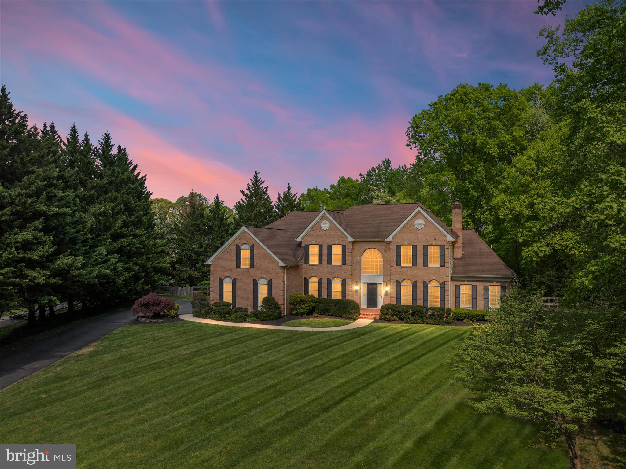 OFFER DEADLINE SATURDAY APRIL 25th 5pm / SUNDAY OPEN HOUSE CANCELED

Some homes impress. Others stop you in your tracks. This is one of them. Set on two private acres in a secluded, pristine setting, this extraordinary 5-bedroom, 5.5-bath estate delivers refined luxury and effortless living at a level rarely seen—especially in this condition. Every inch has been thoughtfully reimagined through an extensive, high-end renovation, creating a completely turnkey experience where design, function, and craftsmanship align seamlessly.  At the heart of the home, a stunning reimagined gourmet kitchen anchors the main level, featuring a massive 12+ foot quartz island with seating for eight, premium Café appliances including a smart double oven, custom built-in pantry, designer lighting, and an adjoining wine bar with beverage fridge and curated storage. The space flows beautifully into a sun-drenched morning room and out to an expansive deck overlooking a private, fenced, level yard—perfectly suited for future pool plans and effortless indoor-outdoor living.  The family room is both dramatic and inviting with soaring vaulted ceilings and a floor-to-ceiling stone fireplace, while formal living spaces offer warmth, flexibility, and refined detail. A standout feature—added by the current owners—is the creation of a true main-level suite, designed for today’s lifestyle with solid wood pocket doors, a private lounge with custom bar, and a spa-quality bath with heated floors, rain shower, and designer finishes, offering exceptional flexibility for multi-generational living or a private guest retreat.  Upstairs, the owner’s suite is a destination unto itself, complete with a hotel-inspired sitting retreat with beverage bar, a fully customized boutique-style closet with center island, and a beautifully renovated spa bath with elevated finishes and thoughtful design. A private ensuite bedroom and a well-appointed Jack and Jill layout complete the upper level with both comfort and functionality in mind.  The fully finished walk-up lower level delivers exceptional entertaining space with a custom granite wet bar and expansive recreation areas. Daily living is elevated with a redesigned mudroom featuring custom built-ins, a fully renovated laundry room with floor-to-ceiling cabinetry, and a three-car side-load garage equipped with smart technology.  Extensive upgrades throughout include wide-plank hardwood flooring across both staircases and the entire upper level, custom closet systems in every bedroom, plantation shutters, designer lighting and fixtures, curated paint selections, and integrated smart home features including security, lighting, garage access, and water systems. Two brand-new high-efficiency Bosch heat pumps, whole-home water filtration, reverse osmosis system, and numerous mechanical upgrades ensure both comfort and peace of mind.  Surrounded by other fine homes and offering both privacy and prestige, this property remains incredibly convenient to Washington, Baltimore, Northern Virginia, and major airports. This is more than a home—it’s a statement, a retreat, and a rare opportunity to own something truly exceptional.