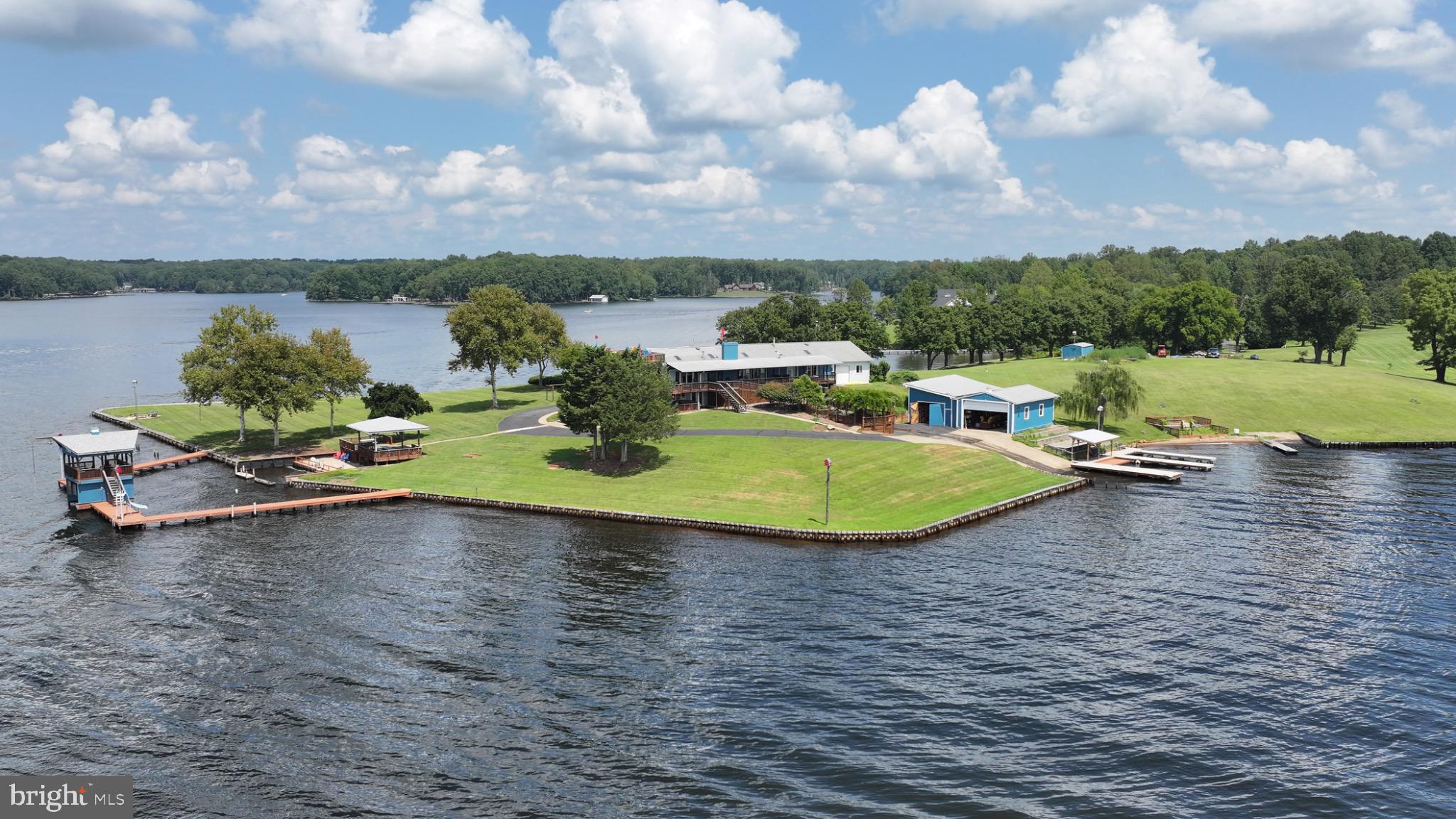 From the moment you arrive, it’s clear this is a place designed for family, connection, and lifelong memories. This extraordinary Lake Anna estate offers a rare opportunity for generations to gather—where grandparents can host children and grandchildren, and where those grandchildren, in turn, can grow up returning year after year to a place that feels like their own.

Set on one of Lake Anna’s most remarkable point lots, this deep-water property provides expansive panoramic views, exceptional privacy, and room for everyone to spread out and enjoy. Encompassing 1.55 acres of fee-simple land, an additional 1.66 acres of Dominion Shoreland, and an impressive 1,260 feet of bulkheaded shoreline, the setting is as impressive as it is inviting.

With so much to experience across the property, children and grandchildren will find endless opportunities for fun and adventure. From swimming and boating to exploring the grounds, this private estate creates the ideal environment for making memories. There is ample space for grandchildren to invite friends from school, host weekend gatherings, and even welcome entire sports teams for celebrations at the lake.

Outdoor amenities include shaded gathering areas, whimsical birdhouses, three charming gazebos, a tranquil koi pond, and multiple recreation and entertainment spaces—each thoughtfully designed to bring people together while still offering quiet places to relax.

The home offers over 5,200 square feet with seven bedrooms and 6.5 bathrooms, comfortably accommodating extended family and guests. Originally built in the 1960s prior to the creation of Lake Anna, the property was later expanded by the current owner, who envisioned a welcoming retreat where family and friends could gather in abundance.

A hangar, previously used for an ultralight seaplane, an adjoining RV garage, and ample space for lake toys further enhance the lifestyle offered here.

This is more than a waterfront home—it is a legacy property, a place where traditions are created, friendships are strengthened, and generations come together to enjoy the very best of Lake Anna living.

See the feature sheet in Documents for amenities too extensive to list here.