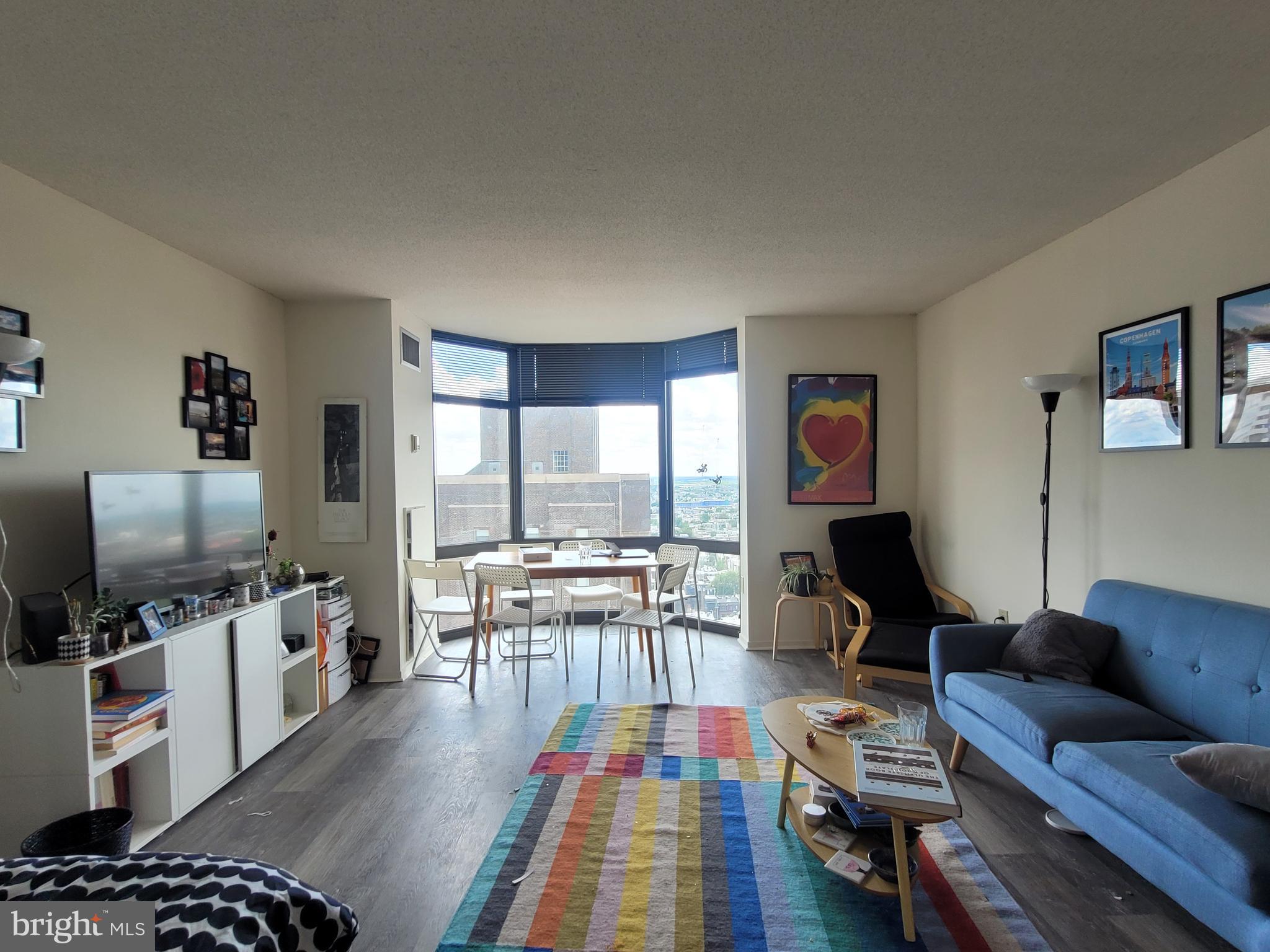 Spacious studio apartment with see-forever city views at the  Wanamaker House. Enter the home through a foyer with three wall closets providing ample storage space. The living/dining space has floor-to-ceiling windows gleaming with natural  light. The well-equipped kitchen features wood cabinetry and a stainless steel appliances. There is a dressing area that leads to a full bathroom with tile floor and a shower/tub. Additional highlights include great natural light and new wood-like vinyl floors throughout. The Wanamaker House is located one block from Rittenhouse Square and provides easy access to both Center City and University City; residents enjoy a 24-hour doorman, a seasonal rooftop pool, a fitness center, and a parking garage available for an additional fee (subject to availability). All common areas were recently renovated including the lobby, hallways, meeting room, amenity lounge, and fitness center, designed by world- renowned architect Cecil Baker.