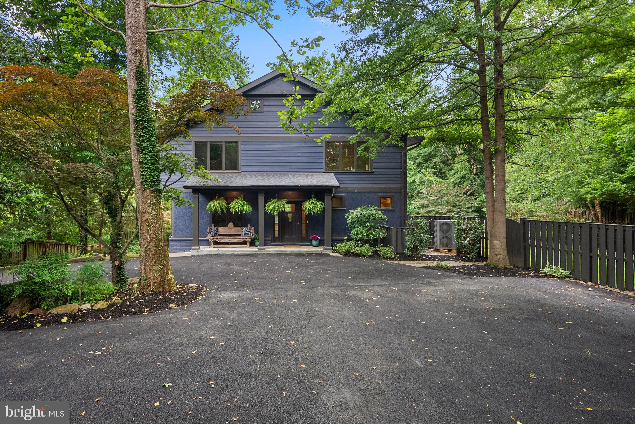 A hidden gem in Cabin John, tucked away on an extremely private half-acre lot just steps from the C&O Canal and the Potomac River with over 5,000 sq feet of living space on three levels.

Completely renovated in 2018, the home boasts a wide-open floor plan with high ceilings, large windows, and abundant natural light. The main level features a welcoming front porch, a spacious foyer, a study, and a mudroom with custom built-ins along with both formal living & dining rooms. The gourmet kitchen includes granite countertops, stainless steel appliances, and a breakfast room and large island overlooking the family room and its stone fireplace. Two decks lead from the family room to a large yard, which includes a fenced grassy area and a pickleball & basketball court.

The upper level includes a primary suite with a luxury ensuite bath, a fireplace, and two walk-in closets. There are three additional bedrooms and two baths, including a guest suite with an ensuite bath and a private balcony. The lower level offers a large recreation room with a stone fireplace, a full bathroom, an oversized one-car garage, and an enormous storage room with two-story ceilings.

The 2018 renovation included new cement siding, windows, oak floors, a new roof, and extensive storm water management. Recent upgrades include a whole-house water filtration system, a new inverter drive heat pump, an industrial dehumidification system, and a Moen Flo smart water shut-off system.

Located just minutes from the American Legion Bridge and downtown Bethesda, this home offers an easy commute to DC, Maryland, and Virginia while providing a bucolic setting perfect for nature lovers.  Easy access to the C & O Canal, the Potomac River, Capital Crescent Trail & Cabin John Creek Trails it is a nature lover's paradise.  1-block to river, canal, neighborhood restaurants, post office & market.