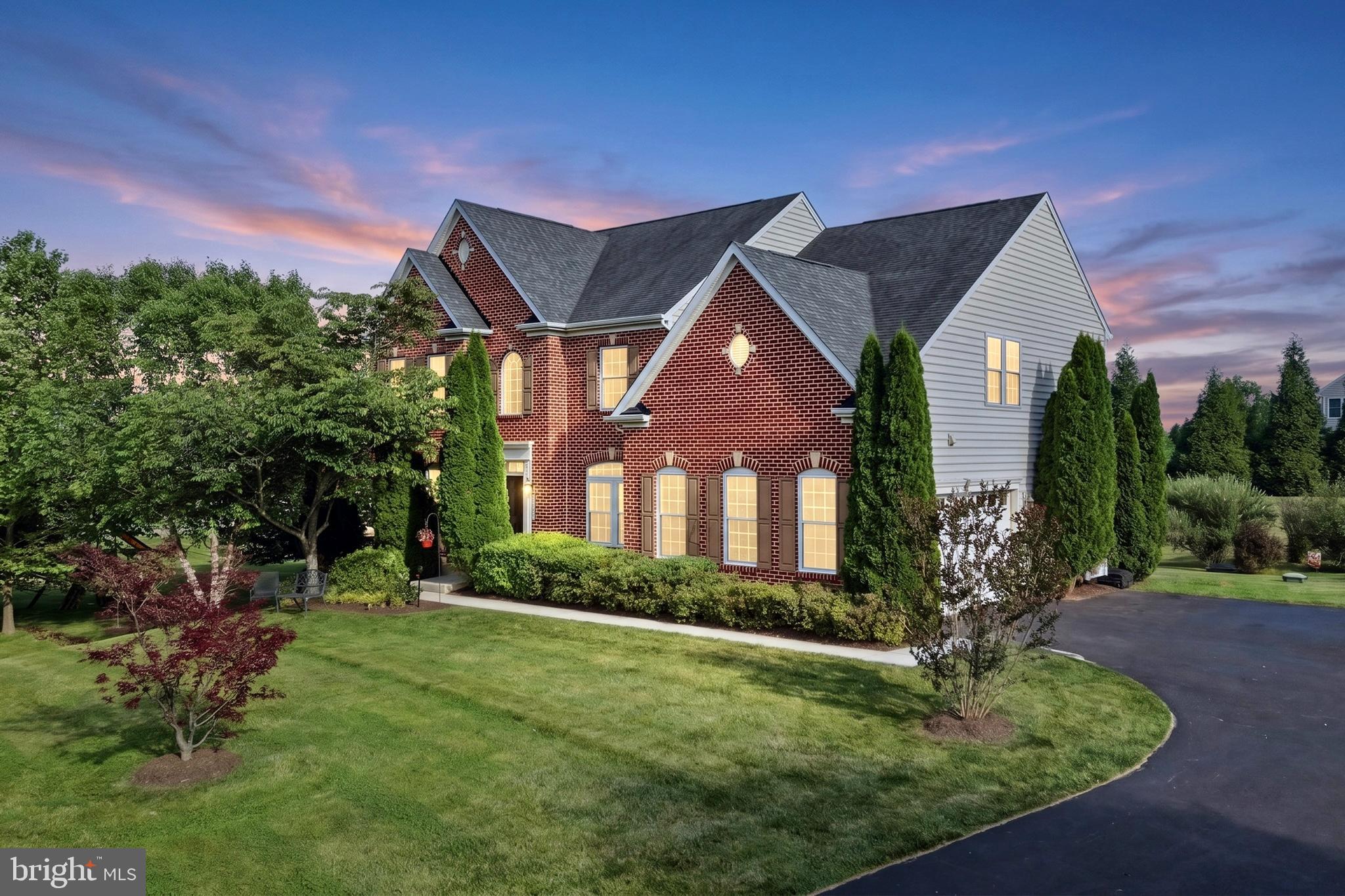 Discover exceptional luxury at 14956 Michele Drive. This stunning brick front estate has over 5,300 square feet of total space situated in the prestigious Warfields II community on a beautiful private lot. Boasting 4 bedrooms, 2.5 baths and an open, spacious floor plan this fantastic home is the consummation of gorgeous form intersecting with outstanding function. Step into elegance with this breathtaking, two-story foyer that immediately sets the tone for the rest of the home. The dramatic high ceilings and gleaming hardwood floors create an incredibly airy and open atmosphere, allowing light to cascade down from the upper level onto a sweeping, open-concept staircase that serves as the focal point of the space. Throughout the main level, thoughtful architectural touches like exquisite moldings, chair rails, and large transom windows create a bright and elegant atmosphere. Just off the foyer, you'll find a formal living room and a spacious home office complete with elegant French doors for added privacy, as well as a formal dining room that connects directly to the kitchen for effortless entertaining. The true centerpiece of the main level is the beautiful, chef-inspired kitchen, which flows seamlessly into a light-filled sunroom and breakfast area. Boasting 42-inch cabinetry, a pantry, and gleaming granite countertops, the kitchen beautifully balances design and function. It opens directly to the welcoming family room, centered around a cozy gas fireplace, the perfect setting for entertaining guests or enjoying a quiet evening at home. The primary bedroom suite is a true private retreat, featuring tray ceiling, an expansive walk-in closets, a serene sitting area or excellent space for an additional home office, and a luxurious, spa-like attached bath. Relax in the soaking tub or enjoy the convenience of a walk-in shower, complemented by two separate vanities. Three additional sizable bedrooms share a convenient hall bath and for added convenience, a dedicated laundry room is ideally situated on this level, providing both privacy and functionality. Featuring a walk-up exit to the backyard, the lower level provides 1,778 square feet of unfinished space ready to be transformed into your dream recreation room, additional bedrooms, a personal gym, or a private office. Set on a sprawling 1.32-acre lot, the beautifully flat backyard boasts breathtaking views and offers the perfect foundation for you to design and build your ultimate outdoor oasis. The thoughtfully designed two-car garage provides generous storage and a convenient side entrance. Blending elegant architectural details with exceptional everyday function, this 4-bedroom, 5,300+ square foot estate offers luxurious, open-concept living and endless potential on a private 1.32-acre lot in the prestigious Warfields II community.