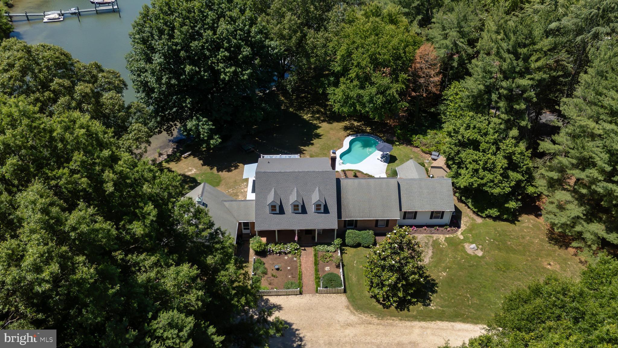 Discover a serene retreat in the heart of Waverly Island Estates, where a major renovation in 2025 breathes new life into this charming Cape Cod home. Spanning 2.77 acres, this property offers a perfect blend of comfort and nature, featuring 4 spacious bedrooms and 2 full and 2 half bathrooms, ideal for both  comfort and relaxation . Step inside to find a beautifully maintained interior with hardwood and ceramic tile flooring, complemented by a cozy fireplace that invites warmth and gatherings. Outside, the allure continues with a personal pool and a stunning view of the Tred Avon River. Enjoy the tranquility of waterfront living with 200 feet of river frontage, complete with a private dock site, perfect for boating, fishing, or simply soaking in the picturesque surroundings. The lot features rip-rap for added stability and a peaceful, no-thru street setting that enhances privacy. With ample parking, including a side-entry garage and driveway space for guests, convenience is at your fingertips. Embrace the lifestyle of riverfront living, where you can kayak, swim, or enjoy a leisurely day on the water. This home is not just a property; it’s a sanctuary waiting for you to create lasting memories. Experience the perfect blend of comfort, nature, and adventure in this exceptional residence. Only a few short miles to downtown Historic Easton, YMCA, shopping and parks.
