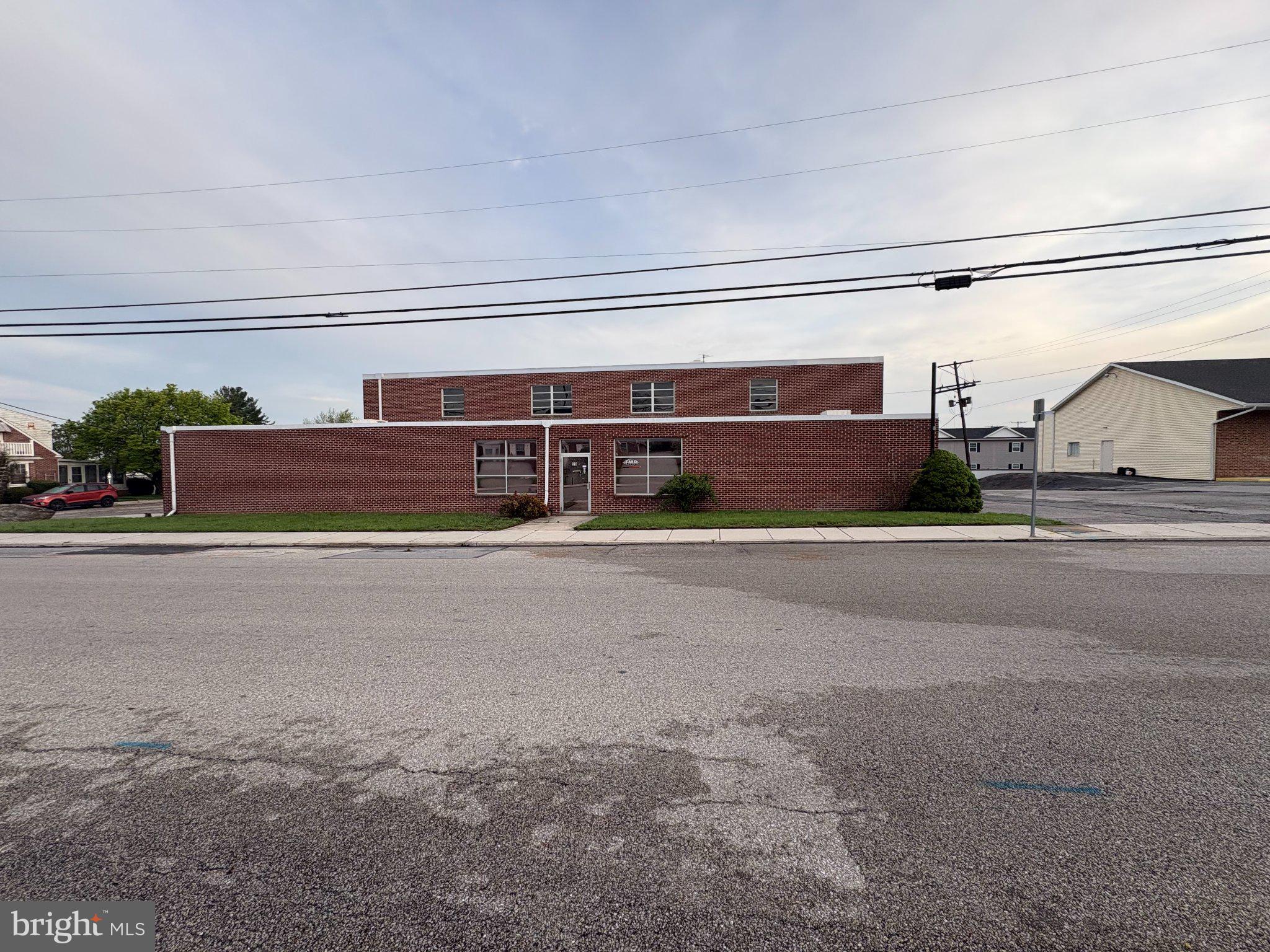 Spacious former Small’s Auto Parts store and warehouse offering a solidly constructed brick and block building designed for long-term durability. The interior features multiple expansive open areas, ideal for a variety of uses, and is serviced by two box truck loading doors along with an additional drive-in door for easy access and logistics. The front portion of the property includes a bright retail or office space with large display windows, creating excellent visibility and a welcoming customer-facing environment. Toward the rear, you’ll find substantial square footage dedicated to storage, assembly, office space, and a functional maintenance/shop area.  The property also provides convenient parking on both the east and west sides of the building, allowing flexibility for staff, customers, or fleet use. Located within the Hanover Borough CB (Central Business) zoning district, the site benefits from a wide range of permitted uses, making it suitable for retail, office, service, or light industrial applications. Positioned just northwest of Hanover, only one block west of Carlisle Street (Route 94) and just south of the well-known “Golden Mile” retail corridor, this location offers excellent accessibility, visibility, and proximity to established businesses and major traffic routes.
