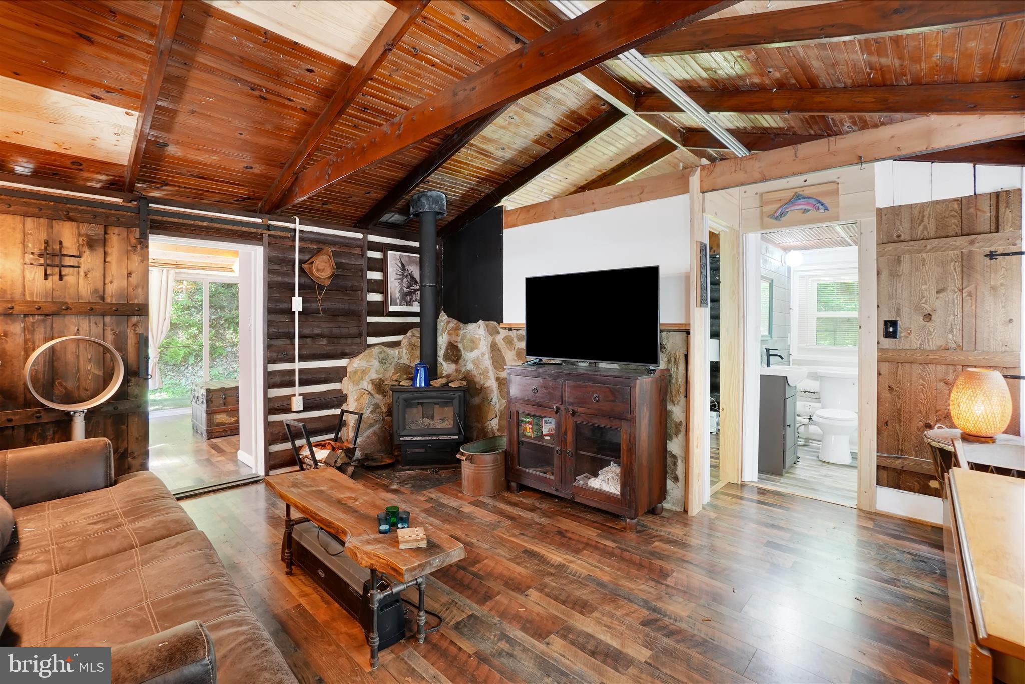 Secluded property on almost 1 acre near STOCKED  GRADE A FISHING stream  Muddy Creek. Come check out this beautifully restored 2-bedroom, 1-bath home tucked away in a peaceful setting. From the moment you pull up the driveway, you’ll be captivated by the charm and character this unique property has to offer.

The exterior features eye-catching cedar shake siding, a goldfish pond, two fire pit areas, and an oversized front porch that’s perfect for BBQs, entertaining friends, or simply relaxing outdoors.
Step inside to a welcoming kitchen featuring a deep farmhouse sink, and a countertop dining area with seating for two at the window overlooking the cozy living room. The living room offers vaulted ceilings and a wood-burning stove, creating the perfect space to relax and unwind year-round.
The light and airy primary bedroom features sliding glass doors leading to a private second porch area, providing a peaceful retreat to enjoy your morning coffee or evening sunsets.
Recent updates include electric, an updated bathroom, updated plumbing in the kitchen and bath, a metal roof that is only a few years old, and the addition of a generator for added peace of mind.
This home is truly an entertainer’s dream, offering the perfect setting to gather around the fire under the stars during warmer months or cozy up inside during the winter  and watch your favorite movies, seller uses T-mobile WIFI  let your worries melt away.
Home comes fully furnished. Schedule your private showing today!
