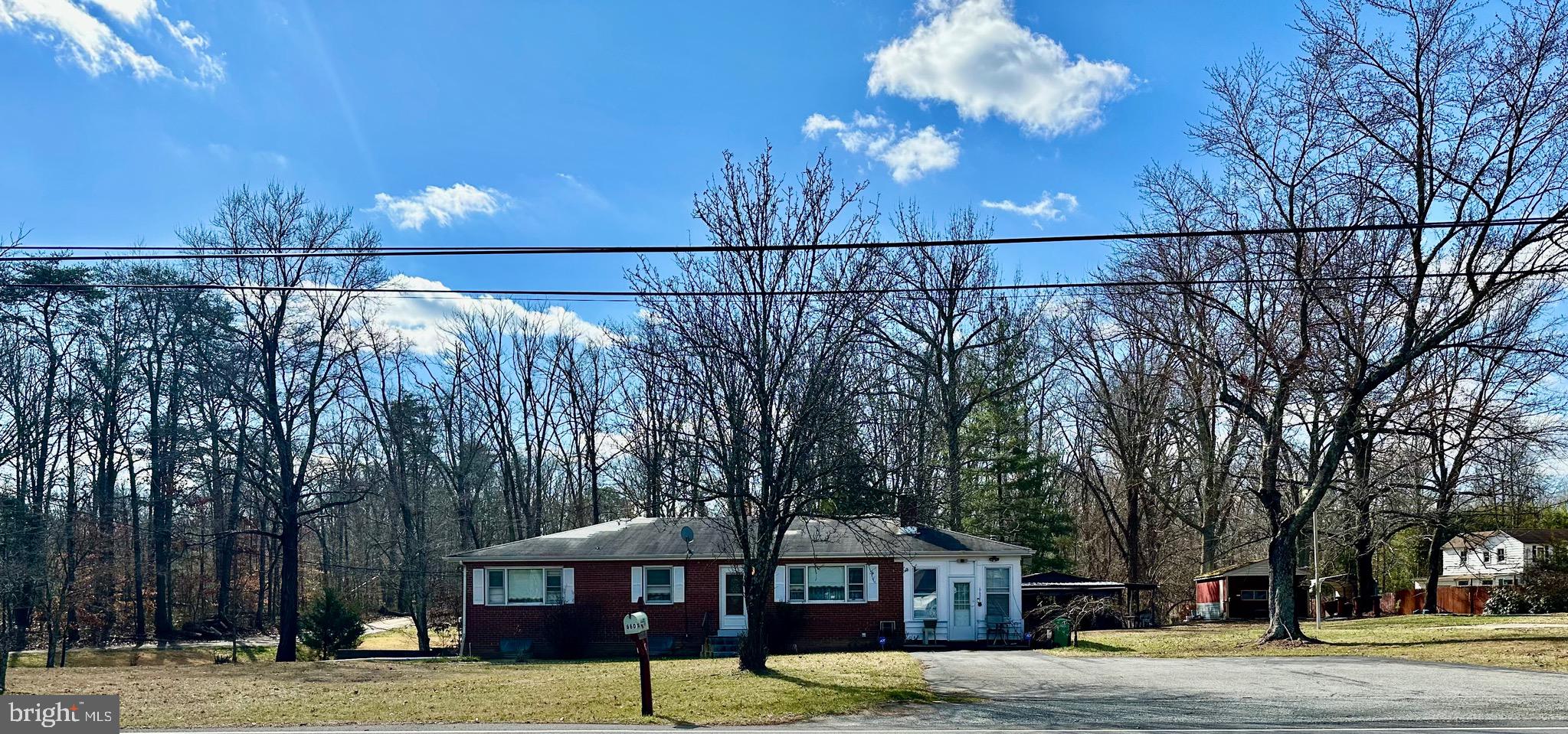 OFFERS ARE DUE BY 5PM TUES FEB 20th AND WILL BE PRESENTED ON WED FEB 21.
Amazing opportunity to build sweat equity in this large brick rambler on 1.68 private acres in the sought after area of Brandywine.  Ready for new owners to bring it back to life and add their personal touches to make this beauty shine again.  The main level offers original hardwood floors under the carpet, a very large kitchen with dining area, 3 bedrooms, and 1 full bath.  The sunroom off the kitchen is perfect for relaxing or indulging in your hobbies.  Two fireplaces plus a pellet stove are perfect for Maryland’s changing seasons.  The lower level has two large open areas, a separate bar area, laundry room, and a non-functional 2nd bathroom.  Plenty of room to add more bedrooms if you’d like!  Additional features include a detached garage, and a covered outdoor entertainment area with brick grill and electric.  Easy commute to the Capital Beltway, Andrews and Bolling AF bases, Washington, DC and Baltimore.  Property being sold strictly AS-IS. PLEASE NOTE: SELLERS ARE IN PROCESS OF REMOVING PERSONAL PROPERTY.