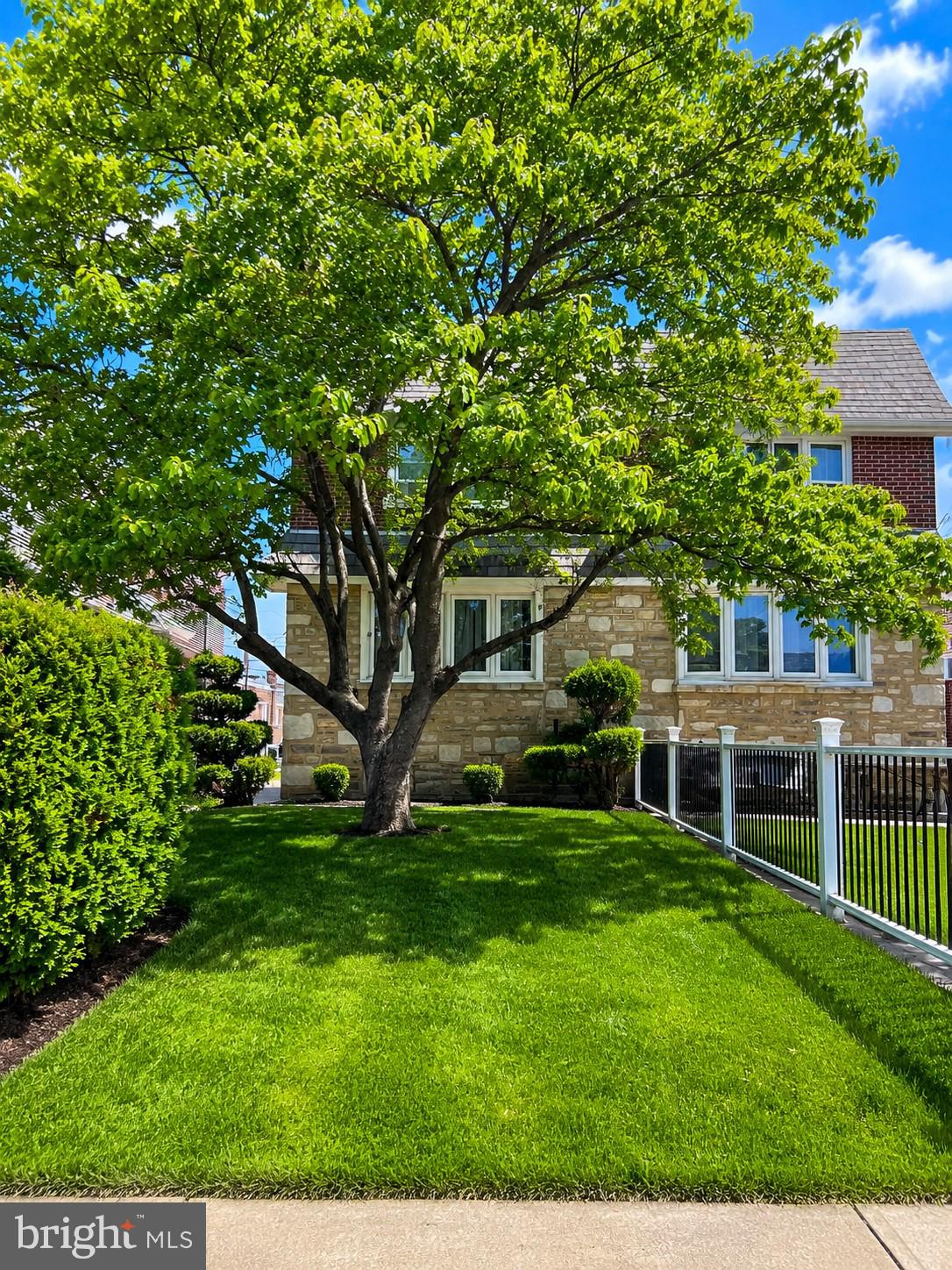 Welcome to this well-maintained twin home located in the highly sought-after Rhawnhurst neighborhood. Featuring attractive curb appeal with professional landscaping, a front patio, and two convenient side entrances, this home offers both comfort and functionality. Inside, the main floor boasts a spacious living room, formal dining room, updated powder room with pedestal sink, and a modern eat-in kitchen complete with stainless steel appliances and access to the fenced side yard. Upstairs, you’ll find a generous primary bedroom with a private full bath, dual closets, and a wall alcove, along with two additional bedrooms and a beautifully tiled hall bathroom. The finished lower level includes a cozy family room, separate laundry area, and access to the rear driveway and attached garage. Additional highlights include central air conditioning, hardwood flooring. The property is currently tenant-occupied with monthly rent of $1,900 on a month-to-month lease. The tenant is flexible and can either remain in place for an investor buyer or vacate prior to settlement for an owner-occupant. The property sod AS-IS condition.