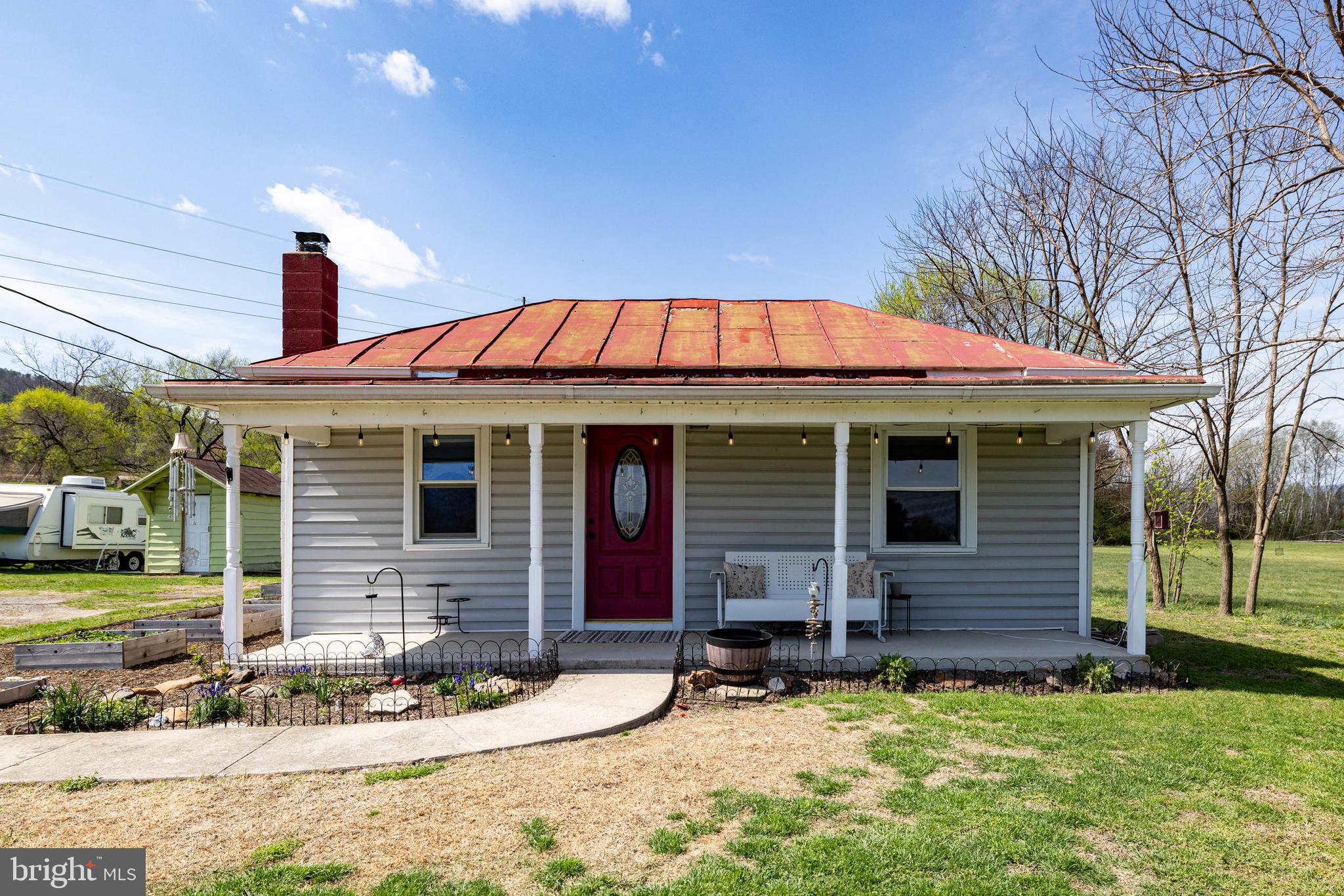 **Seller offering a $10,000 CLOSING COST CREDIT with a full list price offer!** This adorable 2-bedroom, 2-bath bungalow is in excellent condition and full of thoughtful updates! Recently PAINTED ROOF, VAPOR BARRIER INSTALL, AND MOLD REMEDIATION completed spring of 2026! Located just outside the town limits of Stanley, this home offers a spacious open yard with beautiful mountain views—perfect for peaceful country living. Lovingly maintained, the home features fresh interior paint, a new UV water filtration system (2023), hot water heater (2019), all-new light fixtures (2025), updated shower heads and faucets, and refinished hardwood floors. The living room includes newly built custom shelving that provides ample storage while doubling as a unique built-in kennel for two large dogs, complete with a small electric fireplace for added warmth and a dedicated space for food and water bowls—perfect for pet lovers! Outside, enjoy raised herb beds, a generous yard, and a charming front porch, ideal for relaxing with your morning coffee while taking in the scenic surroundings. This home offers the perfect blend of comfort, functionality, and charm in a serene setting.