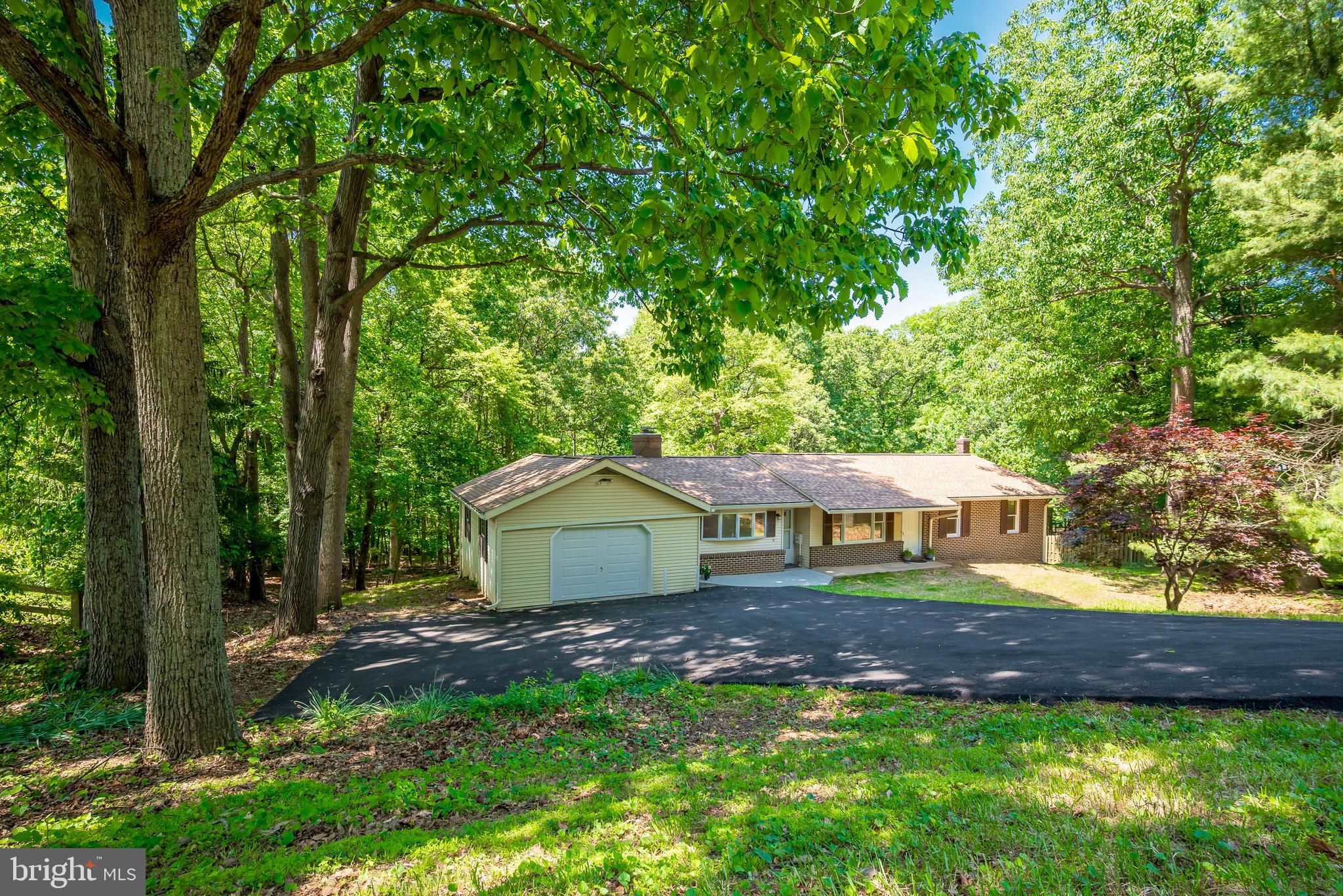 New, New, New – Over $100,000 in upgrades and renovations for this 3Br, 2Ba, 2,888 total sq. ft., home on a gorgeous 1.4+ acre lot in the sought-after, quiet, Mill Bottom neighborhood in the charming town of Mt. Airy, MD.  This home is perfect for those who enjoy primary floor living.  Loads of natural light fill the rooms provided by large windows, new  skylights, and patio doors.  Gather for family living in the great room, brightened with skylights, bow windows, glass patio double-doors, soaring ceilings, and fireplace.  Polished hardwood floors shine throughout first floor.  Entrance through living room or Great Room.  All new kitchen with gorgeous quartz countertops, and stainless appliances.  Experience breakfast looking out over nature through sparkling glass doors.  Renovated full baths accentuated with modern lightening.  Enjoy entertaining your friends on the fabulous back deck that runs across the length of the house overlooking a huge, green, lush backyard that backs up to wooded privacy.  Cozy-up for movie night in front of the wood burning stove in the finished, walk-out lower level.  Set-up a large private office, study, or playroom in the additional room in the basement. Spacious laundry room with convenient table for folding.  Room has brand new washer, dryer, and basin (2026).   Utility room includes new water heater and pressure tank (2025).  Additional bonuses to this home include a cedar closet, brand-new roof, chimney crowns, and gutters, as well as replaced well-pump (2026), and new heat pump/air conditioning (2026), and freshly paved driveway.  Get creative in the oversized garage perfect for adding your own workshop. Turn-around driveway with room for multiple vehicles including a parking pad at the top of the driveway.  Easy access to Baltimore and Washington DC, located along the I-70 Corridor connecting Frederick, Carrol, Howard, and Montgomery Counties.  Minutes to historic, downtown, Mt. Airy and plentiful shopping and restaurants.  No HOA or condo fee.