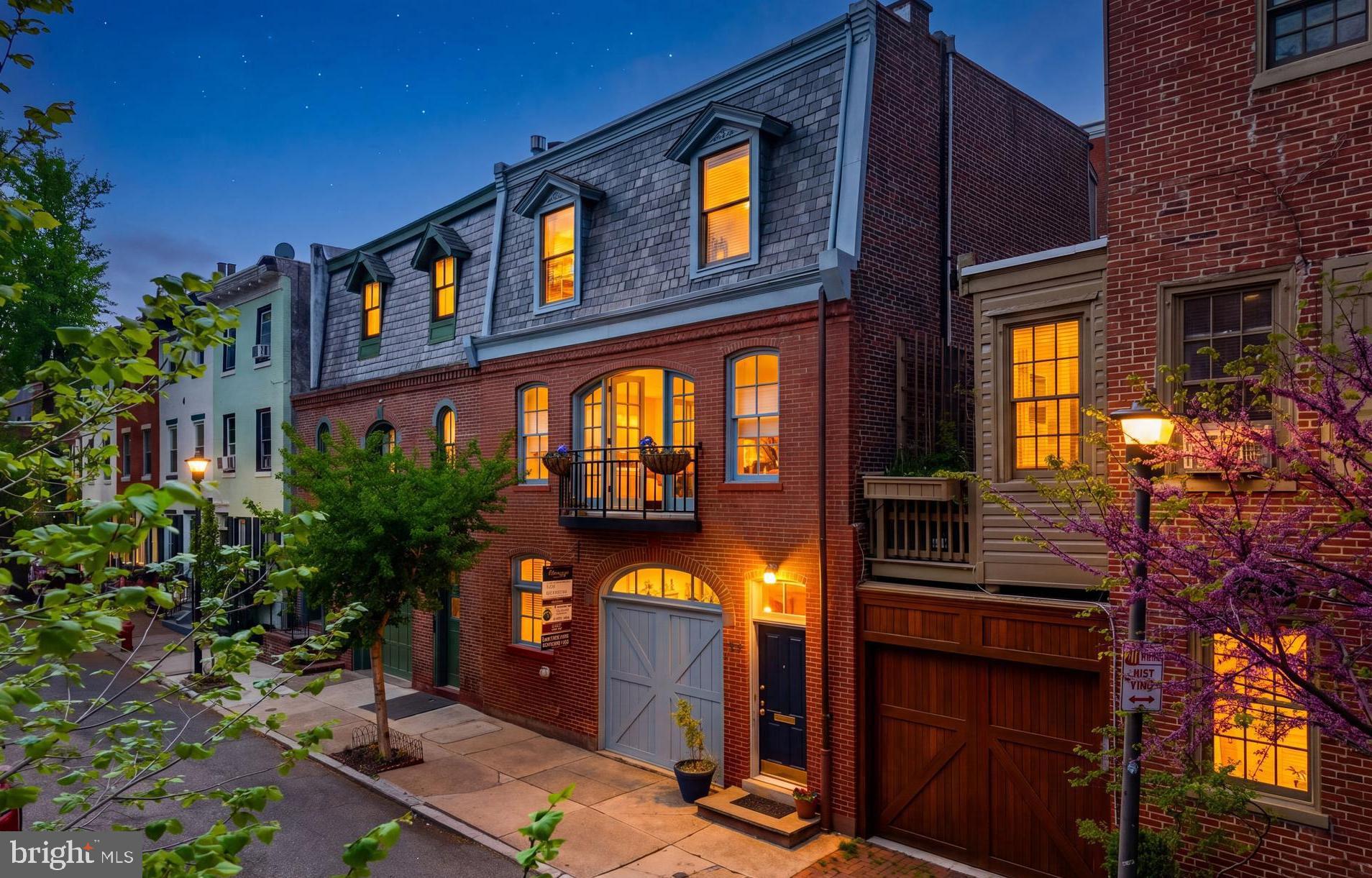 Set along one of Fitler Square’s most picturesque, tree-lined streets, 406 S. Van Pelt Street is a rare and storied offering—a 25-foot-wide carriage house dating back to 1805, quietly tucked into a block defined by charm, character, and architectural depth. With its stately brick façade, classic carriage-style proportions, and Juliette balcony overlooking Van Pelt Street, the home carries a sense of history that is both grounded and romantic—where the past is felt, and the future is full of possibility.
Spanning approximately 2,200 square feet across three levels, this three-bedroom, three-bath residence offers exceptional width, volume, and versatility. Once designed to house horse-drawn carriages, the home still reflects that legacy today—with the rare opportunity to reintroduce garage parking on the first level.
Beyond a slate-floored vestibule, the entry level unfolds into a generously scaled family room wrapped in rich walnut paneling—warm, inviting, and full of character. Formerly the carriage bay, this flexible space can function as a den, media room, or home office, while also offering the ability to convert back to garage parking.. Toward the rear, a private bedroom suite with a full vintage bath creates a quiet retreat for guests or extended stays. This level is completed by a cedar closet, dedicated storage room, and a utility/laundry area.
Ascend to the second floor revealing the home’s most dramatic transformation—a fully renovated, light-filled living level designed for modern living. Stretching across the front of the home, the living and dining spaces are framed by oversized windows and French doors that open to a Juliette balcony overlooking Van Pelt Street. Natural light pours in, creating an airy, effortless flow that feels both elevated and inviting.
At the center, a beautifully updated kitchen anchors the space with clean lines, custom cabinetry, and an expansive island designed for gathering. The layout is seamless and intuitive, connecting kitchen, dining, and living areas in a way that feels both functional and refined. A fireplace adds warmth and depth, creating a natural focal point within the open living space. Toward the rear, a private bedroom suite with a brand-new full bath offers flexibility, along with an additional room ideal for a home office or guest space.
The third floor is dedicated to the primary suite—a quiet, sunlit retreat positioned at the front of the home overlooking Van Pelt Street. Generous in scale, the bedroom offers the kind of proportions rarely found, complemented by built-in shelving and a sense of calm separation from the rest of the home. A walk-in closet provides ample storage, while the adjoining bath—finished in vintage tile—adds character and an opportunity for future customization.
Above, the potential for a rooftop deck introduces an exciting next chapter—offering the opportunity to create a private outdoor escape with sweeping city views, perfect for morning coffee or evening entertaining.
Located within the highly sought-after Greenfield School catchment, and just moments from neighborhood cafés, markets, restaurants, and the green spaces of Fitler Rittenhouse Square, this home offers a rare balance of tranquility and accessibility.
A home defined by history, scale, and opportunity, 406 S. Van Pelt Street invites its next owner to build upon its legacy in one of Philadelphia’s most beloved neighborhoods.