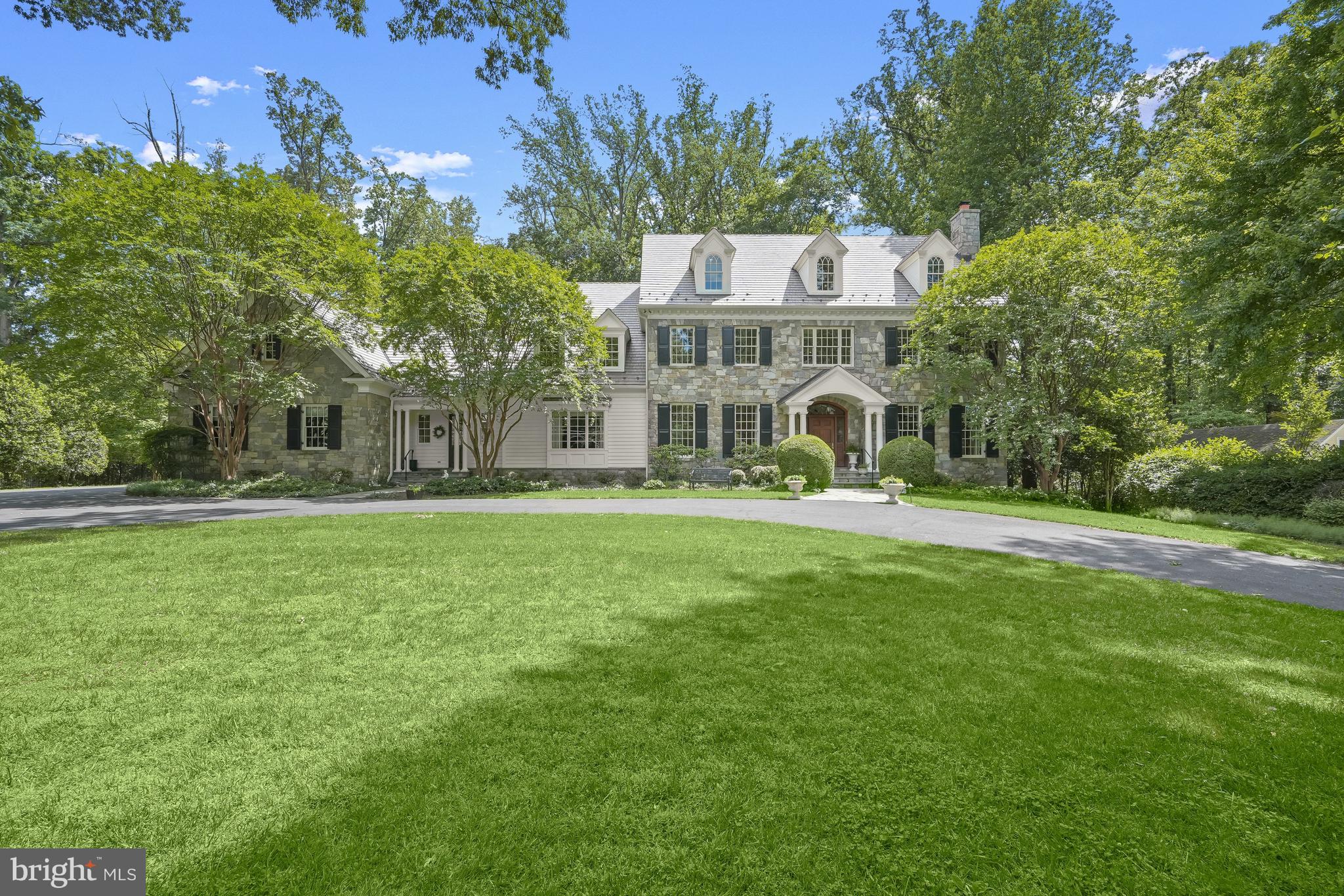 YES, PLEASE!!!! This is swoon worthy and the curb appeal is just the beginning - the perfect stone house in the perfect setting just beyond Congressional Country Club and within walking distance to Potomac Village! With approximately 11,000 square feet of light-filled finished space and set on just under an acre, this home is exquisitely presented and offers fabulous scale and balance perfect for everyday living and all styles of entertaining - from intimate to large gatherings. Set back from the street and accessed via the circular driveway, the home’s entry leads into a gracious foyer and main level featuring 10’ ceilings. Spacious formal living and dining rooms flank the foyer, accessed through arched openings with detailed millwork finishes and featuring floor to ceiling windows and beautiful moldings. Living spaces beyond include an expansive kitchen with a separate window filled breakfast room and access to the glorious screened porch, amazing family room with coffered ceiling and stone fireplace, wood paneled library/office with fireplace, second office (or main level bedroom with a dedicated full bath!), the first of two laundry rooms, powder room, wet bar, ample closets and walk-in pantry, and the oversized three car garage. The wonderful primary suite with fireplace also includes a spectacular bath with soaking tub and glass-enclosed shower, dual walk-in closets, a private and tucked away sitting room, another walk-in closet and access to a bonus room, currently used as storage. An additional three bedrooms, all with ensuite baths, an open sitting area and a second laundry room are also on this level. The third level features two large bedrooms and a full bath. A recreation room with stone fireplace and built-in bar, fabulous theater room, gym, bedroom with ensuite bath, additional full bath, storage and utilities are in the lower level. The newly installed cedar shake roof, generator, movie projector, and more are just icing on the cake! The gorgeous level yard is perfect as it is but can also accommodate a pool and still have plenty of room for play. We don’t see many as special as this one - be sure not to miss it!