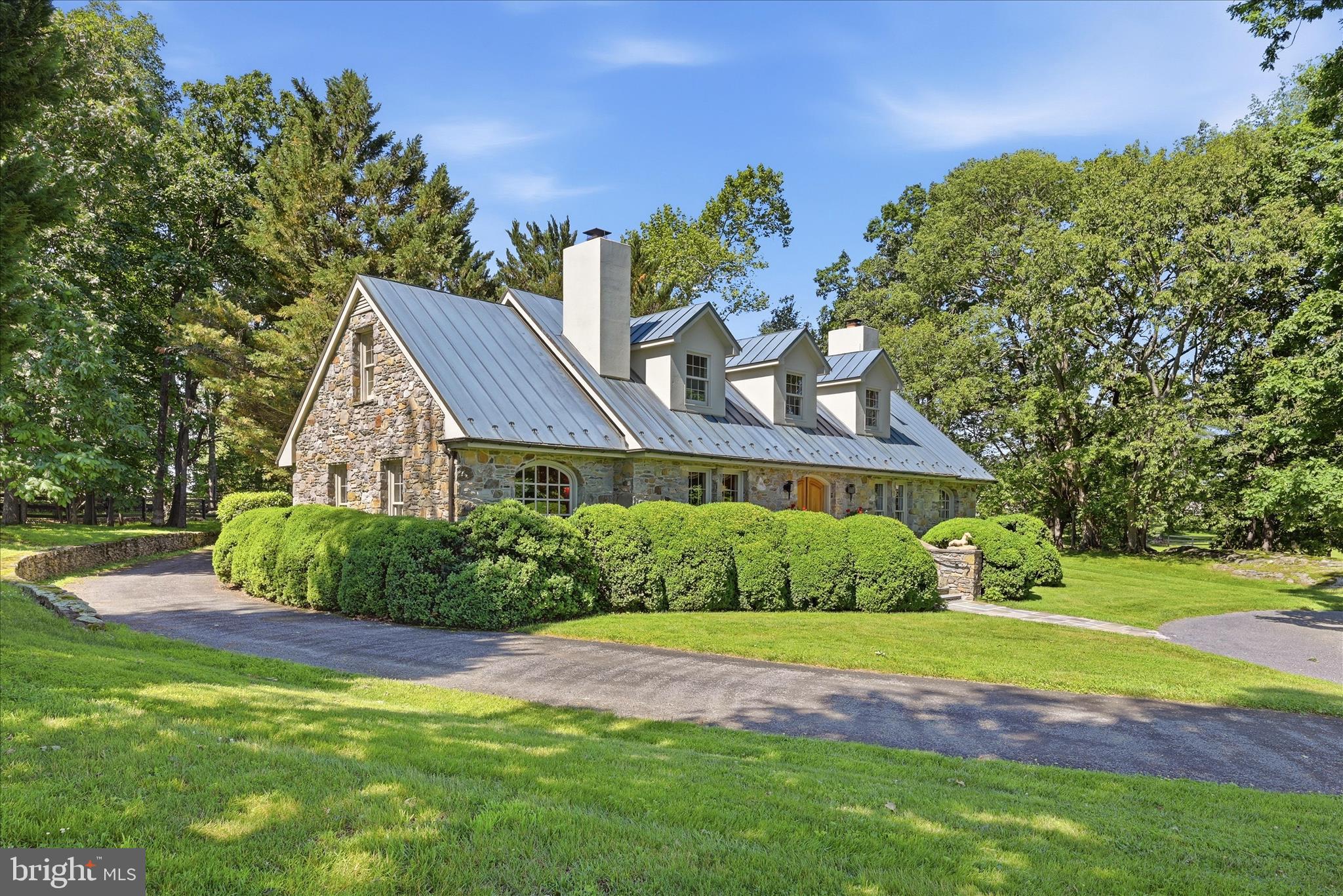 Special home and property set in Virginia’s famed Hunt Country just west of Middleburg, this exceptional estate is the first property on the left in the sought-after Atoka Chase community. Enter through the private security gate and follow the tree-lined drive past the horse barn to a beautifully constructed Cape-style stone residence set on 18 fully fenced acres overlooking an amazing pond and manicured fenced pastures. Designed for both elegant country living and equestrian pursuits, the property features copper roofs and gutters on the house, cottage and garage, extensive landscaping and hardscaping, horse barn with heated office tack room, fenced paddocks, a machine barn, and thoughtfully designed outdoor spaces that capture the beauty of the surrounding Virginia countryside. The main residence offers three bedrooms and two-and-a-half baths with warm, timeless interiors and picturesque views from nearly every room. Sought after primary bedroom suite on the main level. The stone work was done by a local master craftsman in 1990. A separate  cottage includes one bedroom and one full bath and half bath. All new SS appliances, redone kitchen and bathrooms, providing ideal accommodations for guests, extended family, or a farm manager. Propane heating for the main house and heat pump for the cottage. Additional amenities include an indoor heated spa/lap pool, oversized two-car garage, horse barn, and multiple outbuildings supporting both recreational and working farm use. Stone duck house building overlooking the pond with fountain. Multiple paddocks and 3 automatic waterers. This 18 acre gem combines privacy, beauty, and functionality, and this rare Atoka Chase offering presents an extraordinary opportunity to enjoy refined country living just minutes from historic Middleburg. Property has potential to build another home on the property per counsel opinion for the estate. Details provided. By appointment with listing agent.