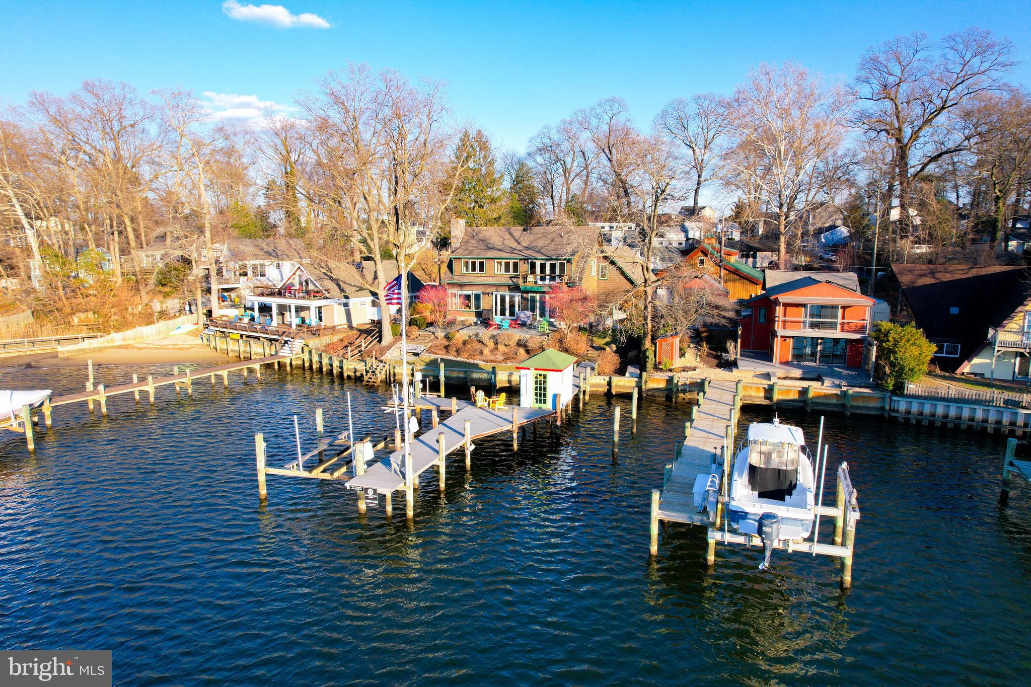Custom waterfront home by multiple award winning builder. Sunset views of tranquil Valentine Creek
from every room, Enjoy an extended pier with 10-foot MLW, and a boat house to secure water toys and
fishing gear, and a 12,500 lb boat lift. A two car garage is attached to the house. A rustic 36’ x 42’ BARN sits on a separate tax parcel. The BARN has a large open space below for a noncommercial workshop, garage, family wedding reception area, storage - almost any use. 
The cedar shake home offers three bedrooms, three and a half bathrooms. The open flowing main level
offers Chefs Kitchen, dining room table space, and living room. Living room offers a masonry stone face
wood burning fireplace from floor to ceiling with flagstone hearth and mantel. Custom corner built-ins
provide the perfect TV placement. Custom built-in bar area keeps everything handy and organized. Wide
plank character white Oak hardwood floor and tumbled limestone floors flow out under your feet to the stunning water views from the Pella windows and doors. The Chefs Kitchen offers high-end designer cabinets, with all the pull drawers and shelves needed. The cabinet faced oversized Sub Zero Refrigerator and Freezer have two doors and blend almost invisibly into the kitchen. A propane Wolf range and oven will please every cook or chef. Enjoy the oversized island with Granite and custom palm tree inlay. The
laundry room offers custom cabinetry, bead board, pegs for coats, storage benches and Miele washer
and dryer directly off the garage entrance.
The second floor offers three bedrooms and three full bathrooms with ample closet space. Wide plank character white Oak Floors throughout this stunning home. The owner's suite offers two closets, views of Valentine Creek from the room and private balcony. Walk-in closet and owner's bathroom are thoughtfully organized. Secondary bedroom offers ensuite bathroom, dual closets and water views. Enjoy the sunshine throughout the upper level thanks to the vaulted design and wood/cable handrails.
The home is also a smart home with Lutron lighting system that is programmable and can be controlled
with Siri, Google, or Alexa. Whole house propane generator automatically assumes electrical load in the event of a power outage.