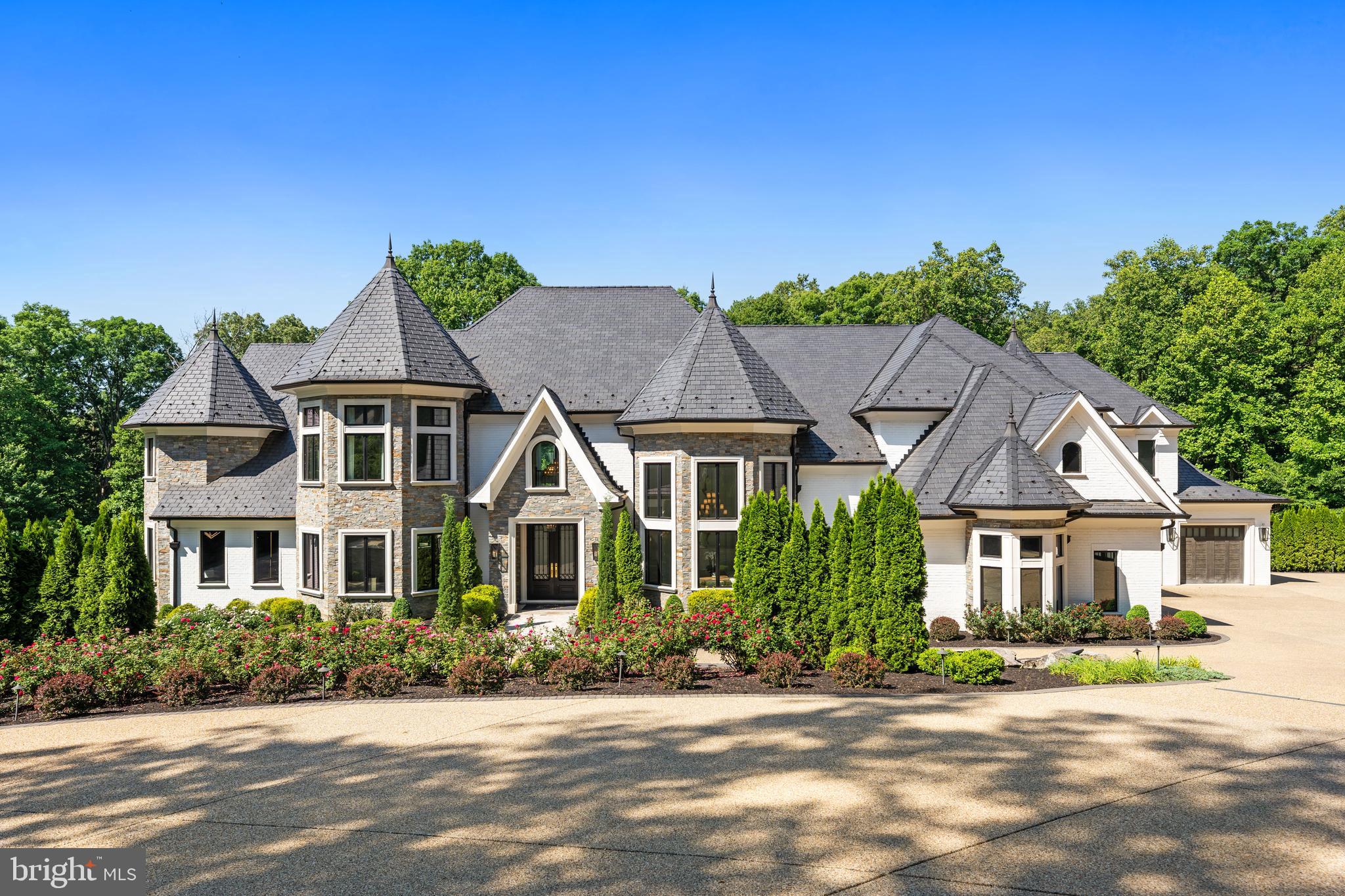 COMING SOON | 1332 McCay Lane, McLean, VA 22101 | $9,500,000
6 Bedrooms | 7 Full Baths | 3 Half Baths | Approximately 14,000 Sq Ft | 1.47 Acres | Built 2022 | No HOA

Welcome to one of the most exceptional luxury homes in McLean, Virginia. Perfectly positioned just beyond the George Washington Memorial Parkway and less than one mile from Chain Bridge, 1332 McCay Lane offers an unparalleled combination of privacy, scale, and proximity to Washington, DC. Georgetown, Embassy Row, and Downtown Washington are all within easy reach, making this estate ideally suited for diplomats, executives, entrepreneurs, and discerning global buyers seeking a premier McLean address.

Built in 2022 by renowned ALM Builders, this approximately 14,000-square-foot French Normandy–inspired contemporary residence spans three elevator-accessed levels and showcases exceptional craftsmanship, sophisticated design, and modern luxury throughout. Situated at the end of a private, tree-lined road on 1.47 acres, the gated estate offers complete privacy while remaining minutes from the nation’s capital. The expansive motor court accommodates more than 25 vehicles, complemented by a four-car attached garage.

A grand foyer introduces the main level, where soaring ceilings and elegant entertaining spaces create an impressive first impression. Formal living and dining rooms flow seamlessly into a sun-filled great room designed for both everyday living and large-scale entertaining. The gourmet kitchen features a full suite of Miele appliances, custom Composit Italian cabinetry, a large center island, a breakfast area, a butler’s pantry, and a fully equipped catering kitchen. A private office with glass doors and a main-level bedroom suite complete this level.

The upper level is anchored by an extraordinary primary suite featuring a private sitting room with a contemporary ribbon gas fireplace, a spacious bedroom with dramatic tray ceilings, dual walk-in dressing rooms, and a luxurious marble spa bath. Highlights include a soaking tub positioned before a gas fireplace, an oversized glass-enclosed shower with multiple shower features, dual vanities, and separate water closets. Three additional ensuite bedrooms and a dedicated laundry room complete the upper level.

Designed for exceptional entertaining, the walk-out lower level offers a private club experience with a spacious recreation room centered around a stacked stone gas fireplace, a contemporary wet bar, a glass-enclosed wine room, a fitness studio with sauna and steam shower, a state-of-the-art home theater, and an additional ensuite guest bedroom. The lower level opens directly to the resort-style outdoor living spaces.

The heated swimming pool features an automatic cover, a dramatic 24-foot waterfall feature wall, an integrated lounge shelf, and an adjoining spa. Expansive travertine terraces provide multiple outdoor living and dining areas enhanced by professional landscape lighting and whole-property audio.

Additional features include four gas fireplaces, a Generac whole-house generator, Infinity HVAC systems, a central vacuum, integrated smart home technology, comprehensive security and surveillance systems, and whole-home audio serving both interior and exterior spaces.

Located within the highly sought-after Franklin Sherman Elementary, Longfellow Middle School, and McLean High School pyramid, with eligibility for admission to the prestigious Thomas Jefferson High School for Science and Technology.