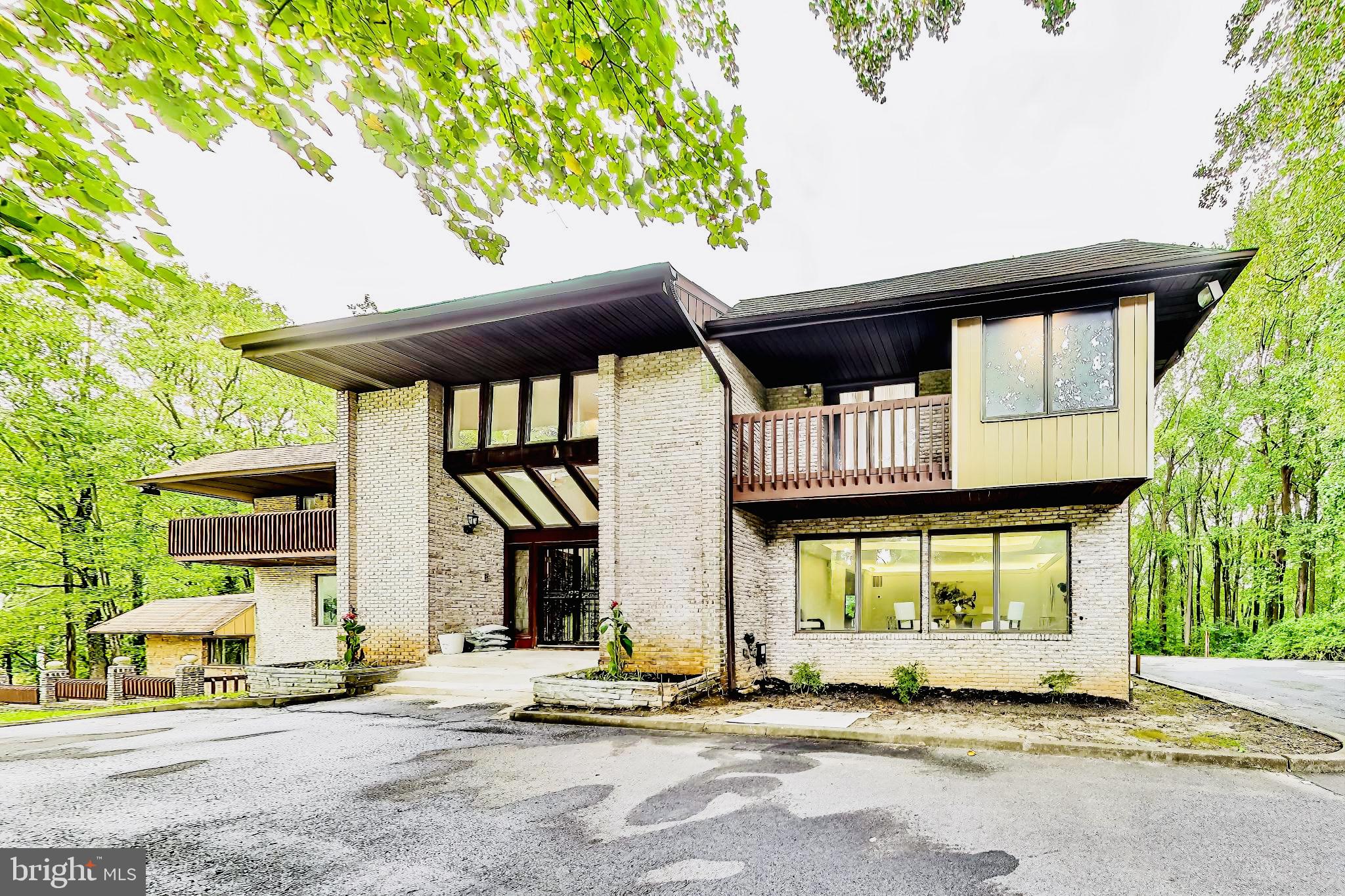 Discover your Dream Contemporary generational home, a luxurious retreat nestled on 7 acres of idyllic wooded land. Boasting an expansive 9,800 square feet, this stunning Grand Estate home features five spacious bedrooms, each with its own private deck, offering breathtaking views and the perfect spot for morning coffee or sunset relaxation.  

Upon entering the grand foyer, you’ll be captivated by the exquisite marble flooring that flows throughout the first level, the Vaulted ceilings while setting the stage for an elegant living experience. 

The impressive family room is highlighted by a sleek fireplace adding warmth and sophistication to the inviting space, ideal for both intimate gatherings and larger celebrations. The kitchen is a pure treat and a chef’s delight. This exceptional home includes modern bathrooms, each designed with a chic, contemporary flair that blends style and functionality. The Spa-like Owner’s suite is a true Oasis the sets the tone for the entire home. The open-concept layout promotes seamless transitions between rooms, making everyday living and entertaining a breeze. The lower level of the home is a true entertainment oasis. 

Enjoy a fully equipped bar, a lively dance floor, a gym, and a relaxing sauna—all designed for your leisure and wellness. This versatile space caters to both downtime and vibrant gatherings, ensuring endless opportunities for enjoyment. Whether you prefer a dedicated corporate style office or a cozy study, this residence offers adaptable spaces to meet your professional and personal needs. 

Surrounded by picturesque nature, you can relish the privacy of this exclusive enclave while savoring all the comforts of modern living. With every bedroom equipped with its own deck, your outdoor escape is just steps away. 

This Home appraised at1,375,000