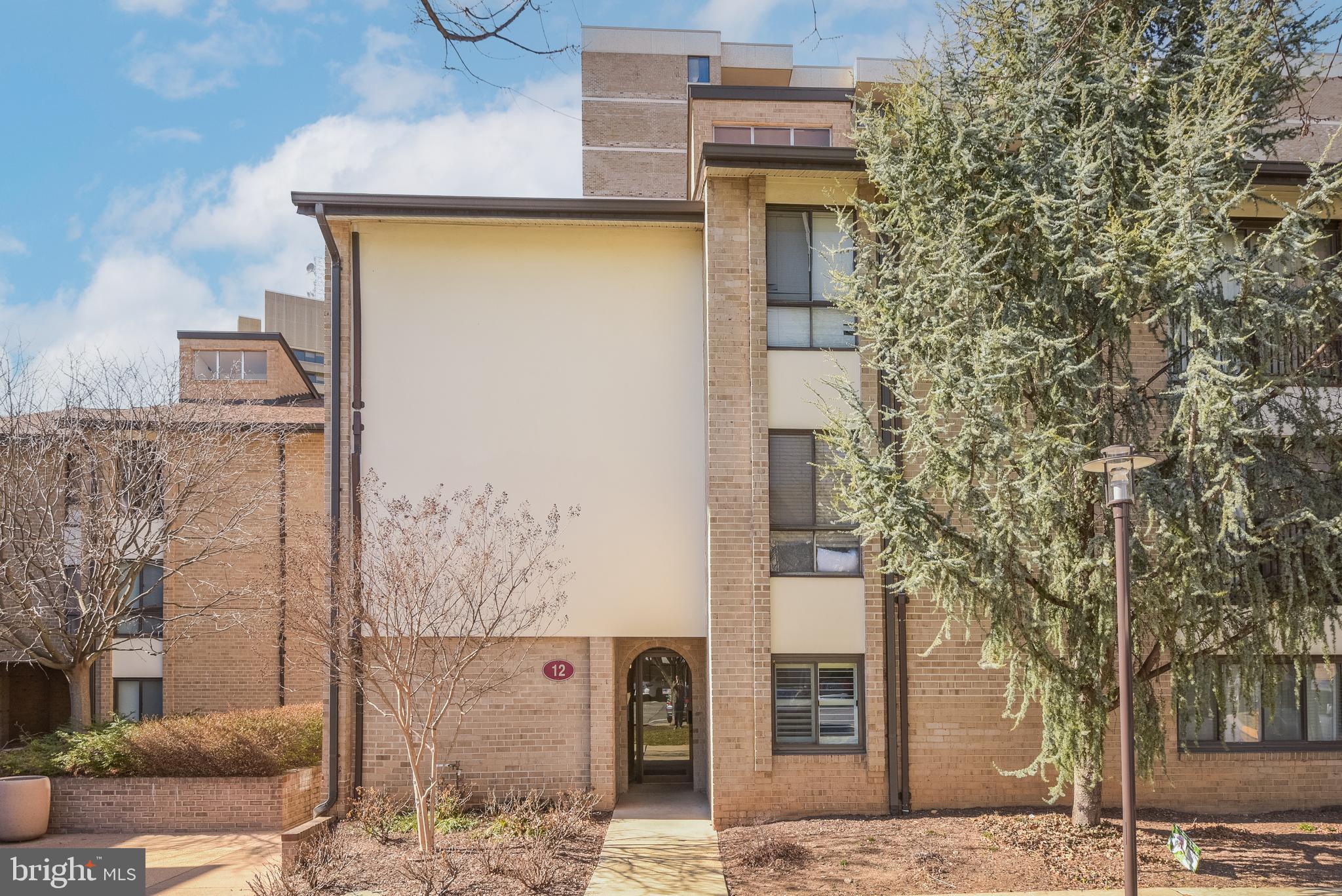 LIMITED TIME OFFER -- The seller is willing to credit 6 month's worth of condo fees towards the buyer at the time of settlement, for any full price offer! This is a nearly $8K value! Offer valid until MAY 19th, 2025. Welcome to 12 Monroe Street, #102 – a beautifully renovated 2-bedroom, 2-bath garden condominium offering the ease of condo living with the feel of a single-family home. This rare unit combines modern design, premium features, and unparalleled convenience in one of the most pet-friendly buildings in Rockville.

Step inside and enjoy contemporary finishes—modern flooring, elegant crown molding, recessed lighting, and dimmable fixtures tailored to your mood. The living room is flooded with natural light, thanks to floor-to-ceiling windows with built-in, remote-controlled shades. A second entrance leads to a spacious private patio—your personal outdoor living room—nestled amid shade trees and blooming greenery. Perfect for morning coffee or evening relaxation.

The open-concept kitchen is a chef’s dream, featuring quartz countertops, a designer backsplash, newer stainless steel appliances (including gas range, microwave, refrigerator, dishwasher, and wine fridge), plus abundant counter space and cabinetry. The oversized peninsula doubles as a breakfast bar and entertainment hub. Adjacent, a windowed dining area easily seats 4 to 8 guests.

The primary suite is your private retreat, complete with a large closet featuring California-style built-ins and mirrored doors, tasteful window treatments, and an en-suite spa-inspired bathroom with a fully tiled walk-in rainhead shower and Wi-Fi-enabled mirror. The second bedroom offers plantation shutters and a walk-in closet. The hallway bathroom includes a bathtub with a built-in niche and another smart, fog-free mirror that streams audio.

This home is designed for comfort and function, with generous storage throughout—including coat and linen closets—plus a stacked washer/dryer tucked conveniently in the kitchen.

The community at Americana Centre offers an impressive array of amenities: ALL-INCLUSIVE Condo Fee covers all utilities—heating, cooling, water, gas, trash removal—as well as concierge services and building maintenance. 24/7 Concierge for package handling and resident support (Building 118). Assigned garage parking with FOB access; surface parking is also available. Secure Storage Cage for overflow belongings. Bike Storage Room with secure fob entry. The Fitness Center in Building 4 has cardio machines, free weights, and more—Outdoor Pool, Saunas, BBQ Grills (seasonally staffed), and changing rooms. Party Room, Monroe Park Access, and Community Events are hosted regularly. The condo association handles annual Patio Power Washing, Landscaping, and Snow Removal. Smart Access Controls for visitors via smartphone. On-call Maintenance Team with semi-annual HVAC inspections, preventative care, and optional in-unit services at discounted rates.

Extensive community upgrades completed from 2016 to 2022 include waterproofing of high-rises, balcony refurbishments, central plant replacement, new sanitary stacks and risers, garage repairs, and cosmetic renovations to lobbies and hallways (paint, carpet, lighting, signage, door hardware). Additionally, the building offers free annual unit inspections, including air filter replacement, drain cleaning, and leak checks.

Ideally located near Rockville Town Center, Metro, bus routes, dog parks, the Rockville Swim Center, and the public library, this home offers the best urban convenience and suburban charm. Enjoy local dining, shopping, concerts, and year-round community events—including summer festivals and winter ice skating—just minutes from your door.

Don’t miss this exceptional opportunity to enjoy turnkey comfort, unmatched amenities, and a vibrant community—all in one extraordinary residence.