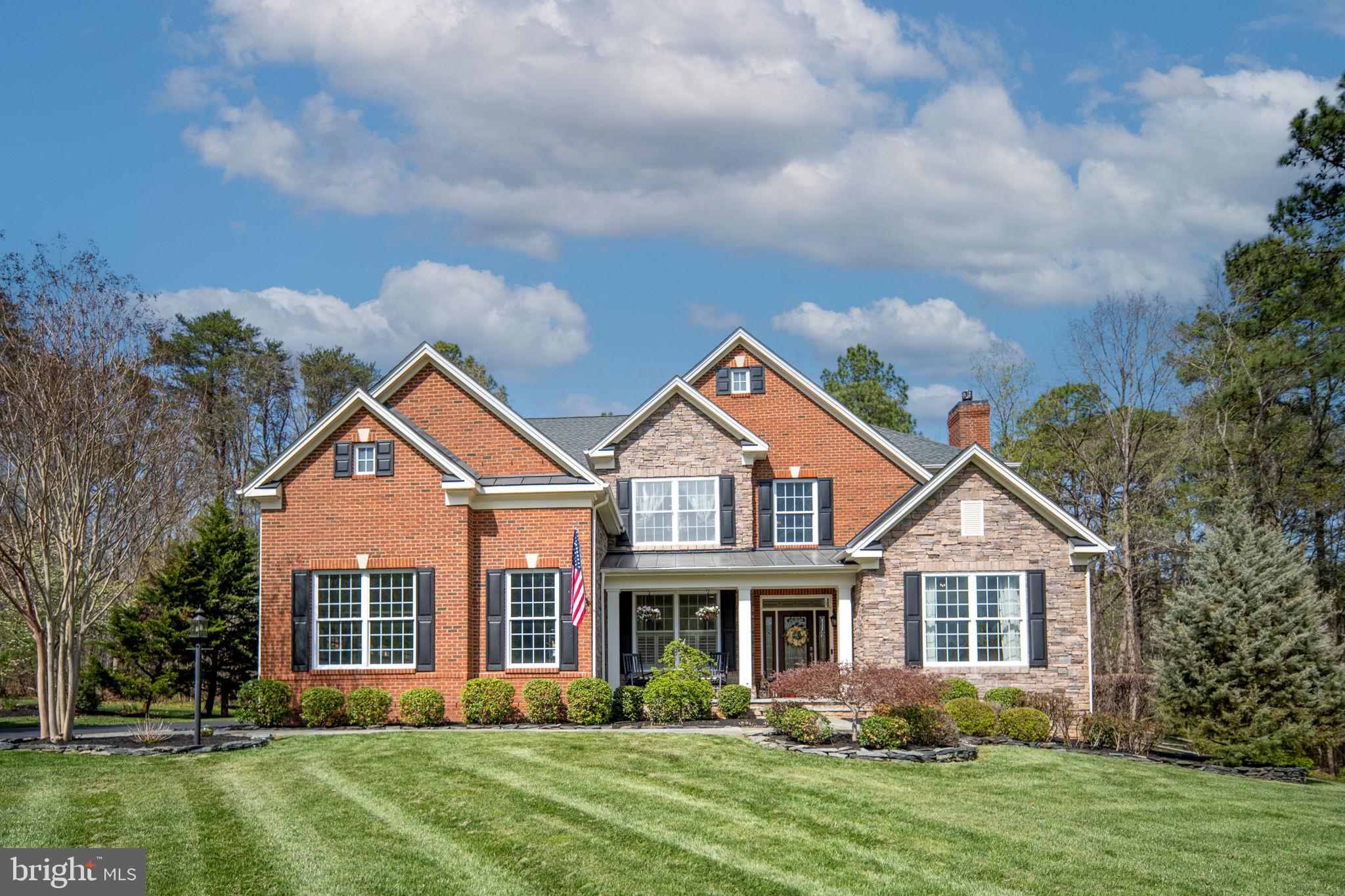 Exceptional value, exceptional home, and an exceptional opportunity in Fawn Lake.

Welcome to this beautifully maintained, move-in-ready residence nestled within the prestigious gated Fawn Lake community, where timeless elegance, thoughtful design, and everyday comfort come together to create an extraordinary place to call home.

A grand two-story foyer filled with natural light welcomes you inside, showcasing a striking designer chandelier and a beautifully crafted staircase with a custom runner that immediately sets the tone for the quality and craftsmanship found throughout the home.

The thoughtfully designed main level offers the perfect balance of sophistication and functionality, featuring a formal dining room, an elegant living room with its own fireplace for intimate gatherings, a private home office, a stylish bar room that can also serve as a music or piano room, a well-appointed mudroom, and a stunning sunroom surrounded by floor-to-ceiling windows overlooking the private backyard, expansive deck, and patio. Rich hardwood flooring flows throughout the main level, adding warmth and elegance to every space.

The impressive family room is the heart of the home, highlighted by soaring coffered ceilings, dramatic floor-to-ceiling windows that fill the space with natural light, and a spectacular floor-to-ceiling stone fireplace that creates an inviting focal point for everyday living and entertaining.

Designed with both beauty and function in mind, the gourmet kitchen features upgraded cabinetry, granite countertops, premium stainless steel appliances, abundant workspace, and an open layout that seamlessly connects to the family room, making it ideal for hosting family and friends.

Upstairs, the luxurious primary suite provides a peaceful retreat with soaring ceilings, a spacious sitting area, an oversized walk-in closet with custom built-ins, and a beautifully appointed spa-inspired bathroom featuring elevated ceilings, warm natural finishes, and timeless design. Three additional generously sized bedrooms provide exceptional comfort and flexibility for family, guests, or additional workspace.

The fully finished lower level expands your living space with endless possibilities. Whether used as a recreation room, guest suite, or in-law suite with its own full bathroom, it offers exceptional flexibility. An additional unfinished area provides the perfect opportunity to create a home theater, fitness room, hobby space, or additional storage tailored to your lifestyle.

Outdoor living is equally impressive. Enjoy an expansive deck with retractable awning, a beautifully designed patio, and a built-in grilling station complete with an outdoor television, creating the ultimate space for entertaining or relaxing. The fully fenced backyard still offers plenty of open space for a future pool, outdoor spa, or your own private resort-style retreat while preserving the home's existing outdoor amenities.

Located within the highly sought-after Fawn Lake community, residents enjoy an unmatched lifestyle featuring a private lake with beach access for boating, kayaking, and fishing, an Arnold Palmer Signature golf course, clubhouse with dining, swimming pool, tennis and pickleball courts, fitness center, marina, walking trails, and 24-hour gated security.

Beautifully maintained and thoughtfully updated, this exceptional home offers luxury, space, and quality rarely found at this price point. With its outstanding floor plan, impressive indoor and outdoor living spaces, and premier location within one of Virginia's most desirable communities, this is truly one of the best values available in Fawn Lake today.