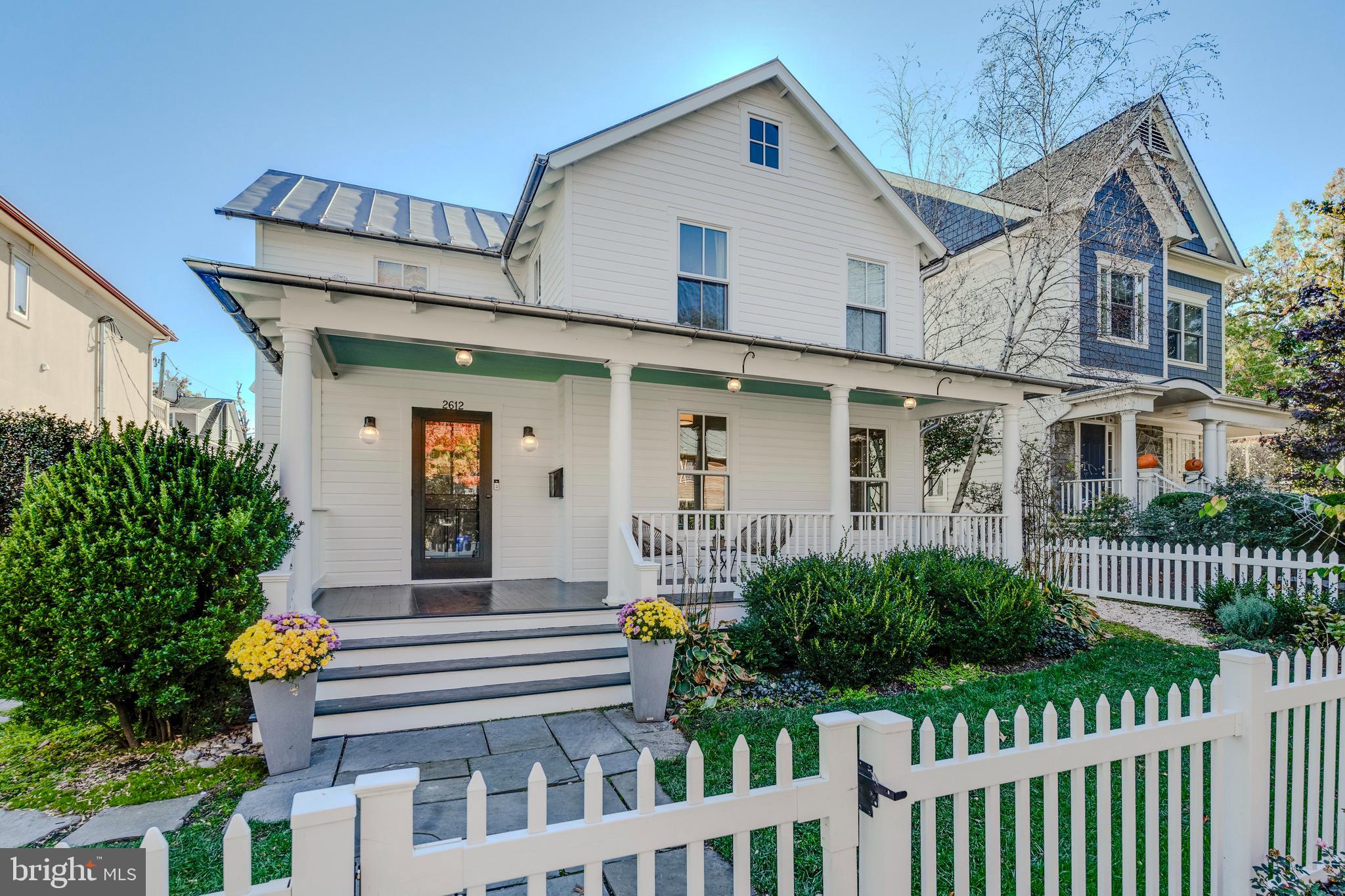 This loving, award-winning, and meticulously renovated modern farmhouse in the heart of Clarendon epitomizes convenient, luxury living on a quiet street. It offers a walk score of 93, is equidistant from Courthouse and Clarendon metros, and is a mere minutes’ walk away from Whole Foods, Trader Joe's, Lifetime Fitness, countless restaurants and stores, Crossing Clarendon playground, Rocky Run Park, and Lyon Village playground. This unique and rarely available home boasts Arlington's Preservation Design Award and Washingtonian Magazine’s AIA Residential Design Award. It seamlessly combines early 1900s charm with modern luxury finishes. The main level's open-concept design is perfect for year-round entertaining and convenient living. From the welcoming front porch to the open dining space and kitchen to the spacious family room with three exposures, it offers an abundance of flow and natural light. The recently redesigned gourmet kitchen features top-of-the-line Thermador appliances, custom cabinets with an abundance of storage, an oversized island, and marble countertops. The upper level includes three generous bedrooms with natural light, including a fully renovated primary suite and bathroom with custom storage, and conveniently located laundry. The rear of the home is a haven for relaxing, entertaining, and gardening with a brick patio, large rear porch, spacious lawn, smart sprinkler system, and raised vegetable garden. A fully fenced-in yard, detached garage, and private parking complete this exquisite property. Don't miss the opportunity to own this lovingly and beautifully preserved, updated, and move-in-ready North Arlington gem.