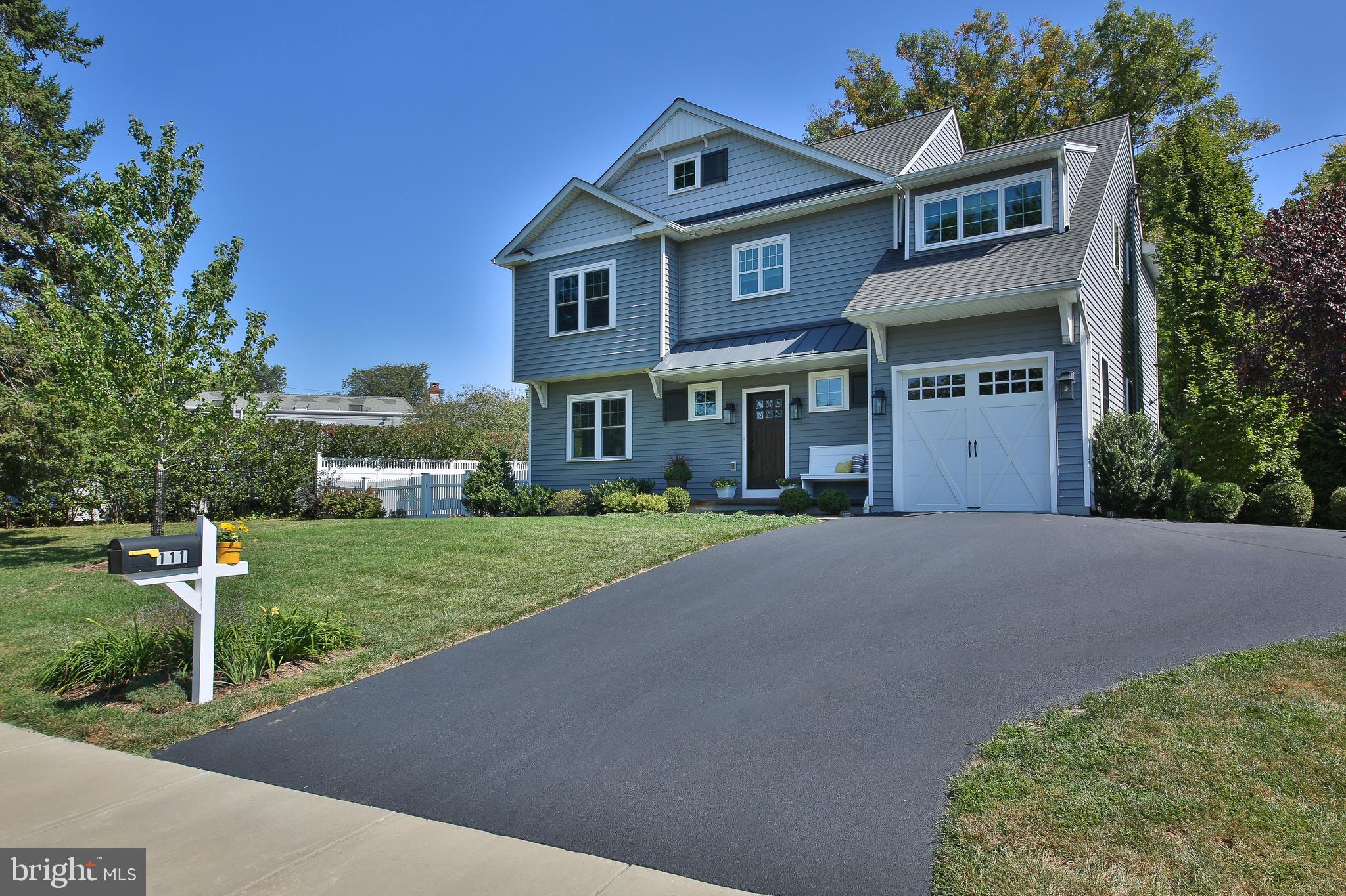 SUNDAY OPEN HOUSE CANCELLED. Newer construction AND walk-to-Wayne? Yes, it’s true! This 5-year-young Colonial has unparalleled curb appeal and is only available due to a job transfer. The charming front porch welcomes you, and once inside the foyer, you’ll immediately notice the espresso hardwood floors and bold accent walls. The oversized living room features a gas fireplace and mantle with timeless millwork as its centerpiece. The living space flows smoothly into the dining area, where there is ample space for a large farmhouse table, and a dry bar with beverage fridge. In the kitchen, you’ll be wowed by the 9ft. ceilings, many 42” cabinets, and stainless appliances, including a 5-burner range with griddle feature. The center island has 4-person seating, pendant lighting, and a built-in microwave. The walk-in pantry is a dream. There is also a cubby area and easy access to the 1-car garage with opener from the kitchen, so unloading groceries is a breeze. A powder room completes the main level. Upstairs, the hallway and owner’s suite boast the same espresso hardwood floors. Step into luxury in the owner’s ensuite bath, where you’ll find a tiled shower with glass doors and built-in bench, a double sink vanity, free-standing soaking tub and separate water closet. The walk-in closet is spacious with custom organization system. The 3 remaining bedrooms are all carpeted, well-sized with ample closet space, and get fabulous morning light. The hall bath has a double sink vanity and a pocket door that separates the tub/shower. A barn door conceals the 2nd floor laundry room, which has a utility sink with storage, built-in drying rack, and space for additional cabinetry. The dry, unfinished basement is currently used as a rec room, and is simply waiting for your inspiration. The tree-lined yard is level and spacious, and already has the white picket fence in place for you! There is a slate patio with access to the kitchen and the shed can house your lawnmower and gardening tools. Most of the home has custom blinds. All systems are only 5 years old, and the neutral finishes in this home can accommodate any style décor, so bring your personal touch! The current owners love taking daily walks on the Radnor Trail. They regularly pop over to the farmer’s market for fresh produce, and visit DiBruno Bros for charcuterie. It is a 12-15 minute walk to the center of Wayne and .5 mile to the Strafford train station. Schedule your showing today!