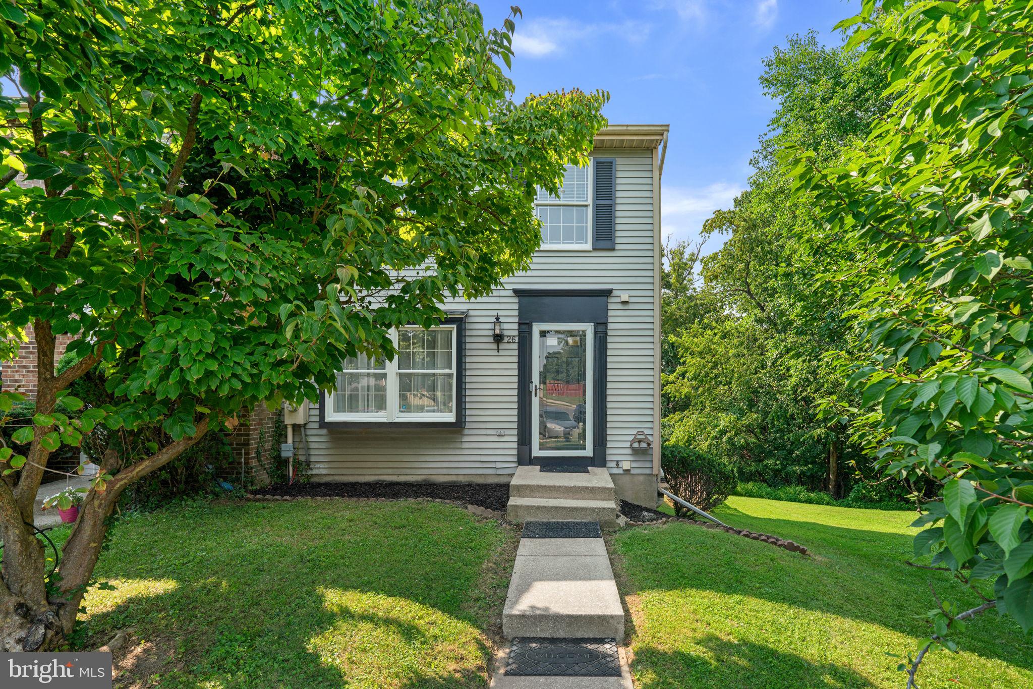Welcome home to this beautifully updated end-of-group townhome offering comfort, style, and a private setting backing to woods! The main level features gleaming hardwood floors throughout the spacious living and dining rooms, an updated half bath, and an updated kitchen with granite countertops, stainless steel appliances, and space for a breakfast bar or small dining table. The dining room opens to a rear deck with brand-new decking boards (2026), creating the perfect spot to relax or entertain.  Upstairs, the spacious primary bedroom offers double closets and private access to the updated full bath. The finished walkout lower level provides additional living space with direct access to the backyard, making it ideal for a living room, home office, or recreation area.  Recent updates include new carpet (2026), luxury vinyl plank flooring in the kitchen and half bath (2026), a new basement sliding glass door (2026), and new deck boards (2026), giving the home a fresh, move-in ready feel. Combining thoughtful updates, functional living space, and a peaceful wooded backdrop, this home is one you won't want to miss!