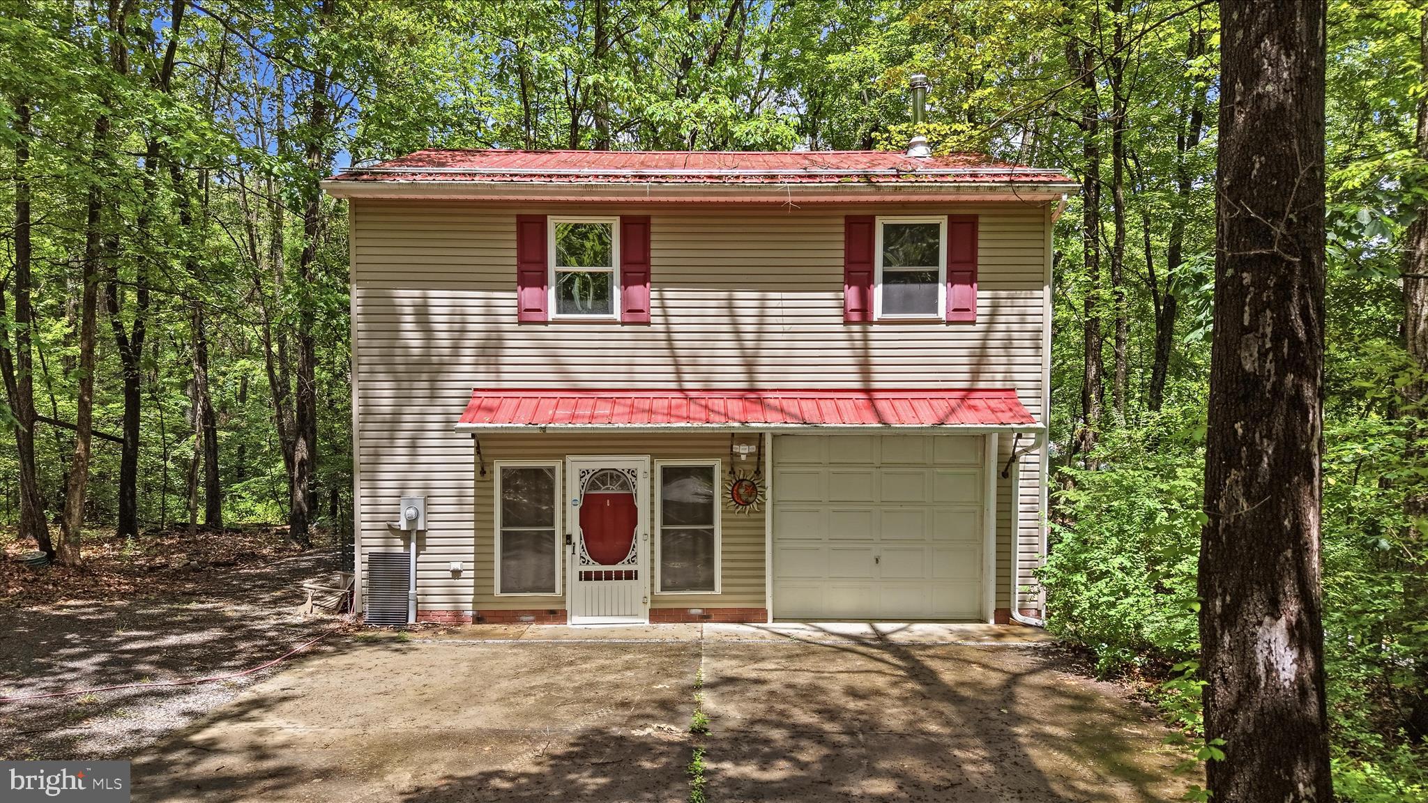 Welcome to 347 Getaway Road — a peaceful retreat on 2 acres in Berkeley County! This affordable 1-bedroom, 2-bath home offers endless potential with a spacious unfinished basement ready for your vision. Enjoy open-concept living upstairs, a 1-car garage, two storage sheds (one with electricity), and RV hookups for water, sewer, and electric. Designed for comfort in every season this home features two mini split systems with efficient heating and air conditioning, complemented by the warmth and charm of a cozy wood stove.   Surrounded by mature trees and open space, this property is perfect as a full-time home, weekend getaway, or future dream home site (3BD septic system in place). Conveniently located near Sleepy Creek Wildlife Management Area and Cacapon Resort State Park, this is your opportunity to enjoy quiet country living with room to grow.