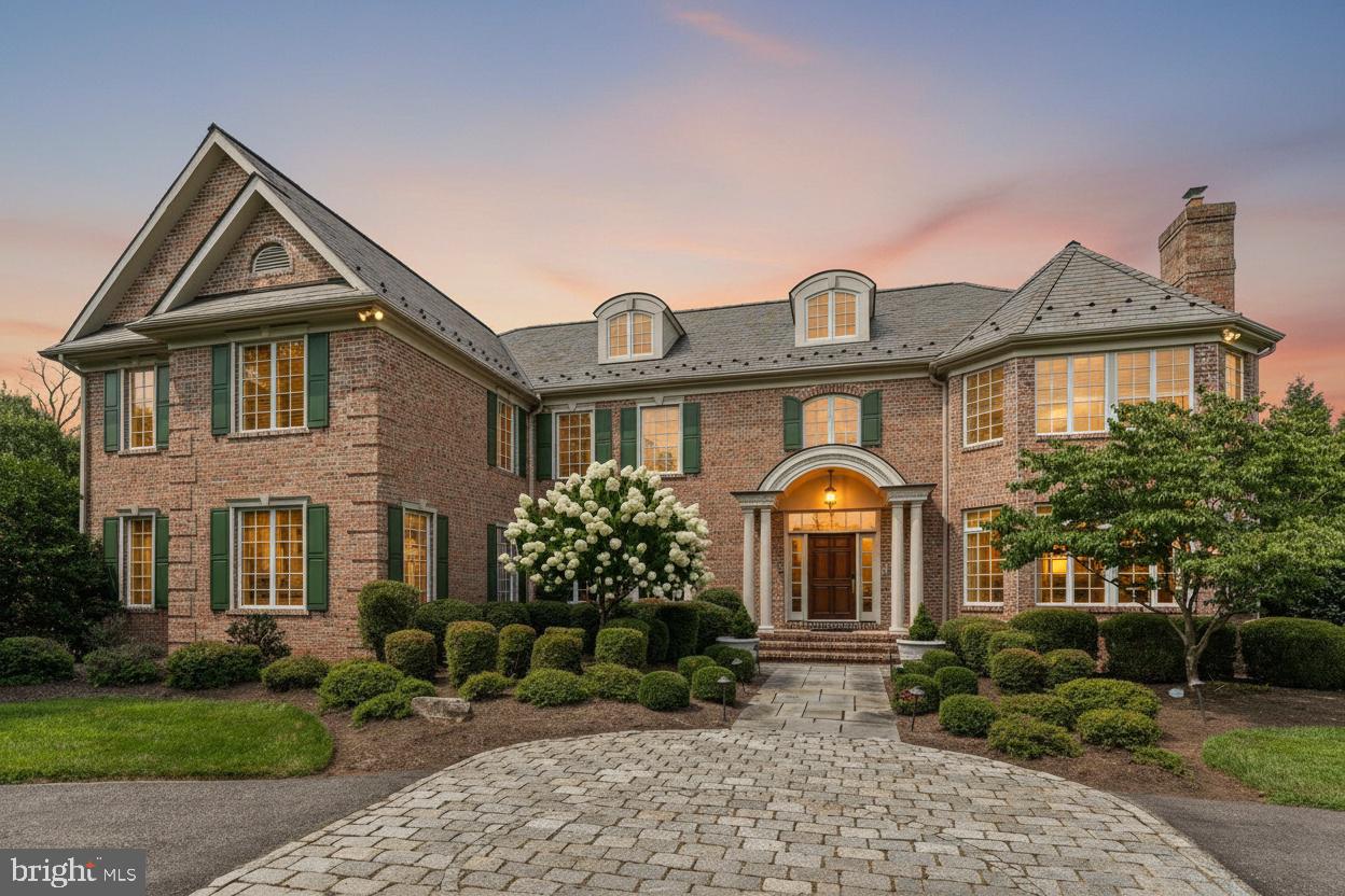 Welcome to 1 Dovecote Lane, a stately 6-bedroom, 8.5-bath residence set on two beautifully landscaped acres in highly sought-after Willistown Township. Blending timeless craftsmanship with thoughtfully updated amenities, this exceptional home offers elegant living spaces, refined finishes, and a layout designed for both everyday living and large-scale entertaining. A grand foyer introduces the home with limestone flooring, raised panel wainscoting, and a sweeping curved staircase. Formal living and dining rooms flank the entry, each richly appointed with detailed millwork, custom finishes, and elegant entertaining spaces. The dining room is accented by a tray ceiling, plantation shutters, and recently installed designer wallpaper, while the formal living room features built-ins and a gas fireplace with marble surround. At the heart of the home, the dramatic two-story great room showcases a coffered ceiling, floor-to-ceiling stone wood-burning fireplace, and custom built-in bookcases. Just beyond, a sun-filled sunroom offers a peaceful retreat overlooking the property. Designed to impress both serious chefs and avid entertainers, the gourmet kitchen features granite countertops and backsplash, a Sub-Zero refrigerator, Wolf range, abundant cabinetry, walk-in pantry, and a butler’s pantry complete with sink and wine cooler. The adjoining breakfast area opens seamlessly to the home’s exceptional outdoor living spaces, including a Trex deck overlooking the fully fenced rear yard and a flagstone patio with built-in grill and cooking station. Privately tucked off the main living spaces, the richly finished study features custom cherry cabinetry, detailed millwork, wainscoting, and a gas fireplace with marble surround. The main level is further complemented by a spacious laundry room, mudroom with full bath access, additional half bathroom, and oversized 4-car garage with latex-coated flooring. Upstairs, the expansive primary suite serves as a luxurious private retreat with a sitting room, tray ceiling, dual walk-in closets with dressing area, and a spa-inspired bath featuring marble floors, granite-topped vanities, whirlpool tub, oversized shower, and private water closet. Four additional en-suite bedrooms complete the second level, each generously sized with designer tile, Kohler fixtures, and custom closet systems. The third floor offers flexible living space with a sixth bedroom, full bath, and sitting area ideal for guests, au pair, or extended family accommodations. The finished walk-up lower level was designed with entertaining and recreation in mind, featuring a custom bar, spacious recreation and game areas, full bath, home gym, and an impressive home theater with updated projector, speakers, amplifier, and sound system. A dedicated dance studio with mirrored walls and professional-grade cherry sprung flooring adds a truly unique finishing touch. Additional recent improvements include dual 20kW natural gas generators, updated paint and lighting, new first-floor HVAC system, newer water heater (2025), WiFi-controlled outdoor lighting and thermostats, and a fully fenced wrought iron rear yard. Offering a rare combination of scale, craftsmanship, comfort, and location within the highly regarded Great Valley School District — while also providing convenient access to many of the region’s prestigious private schools — and just minutes from Malvern, 1 Dovecote Lane presents an exceptional opportunity in one of Chester County’s most desirable settings. Please note some photos have been virtually edited/staged.