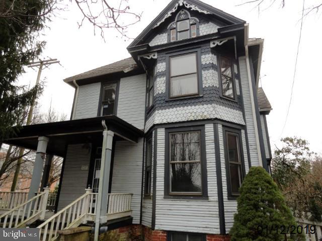 Large home w/loads of potential.  Large rooms throughout.  Features include hardwood floors, 9 Ft 1st floor ceilings, wrap around porch, lots of wood trim  doors, corner lot, walk up attic, detached 2 car garage and more.  Priced to sell, but definitely needs work.