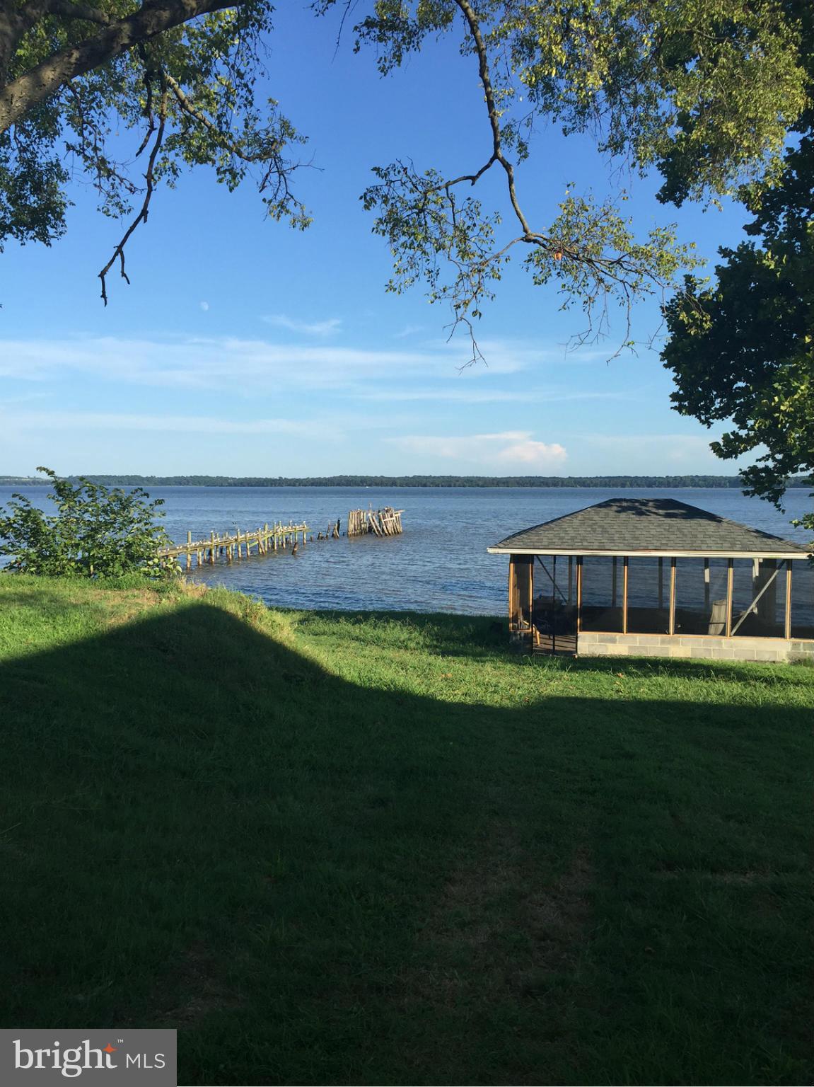 Looking to live on the water?  Want to fish everyday, or just walk on the beach?  This home has all of that, and more.  2 level brick rambler, on large farm.  Access to 8 acres, 200 foot beach, 250 foot dock, crab house, 2 car garage, fenced backyard.  Remodel done, in 2013, to kitchen/dining room combo, living room, and sun room added.  Full basement, with a TV room and laundry room.