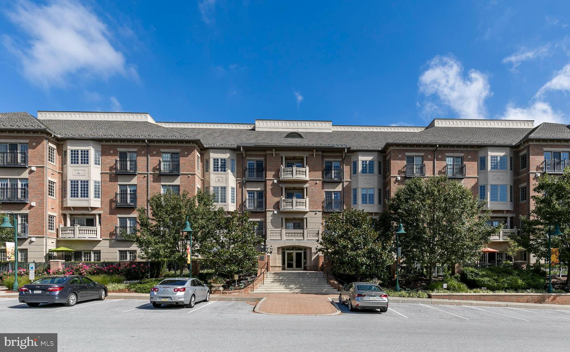 RARE OPPORTUNITY for one-floor, resort-style living at the HIGHLY coveted Wellington Condos in the master-planned community of Eagleview. From the moment you enter this upscale, impeccably maintained building you will appreciate the elegant detailing and craftsmanship that went into the design. Take one of two elevators to the third floor and make your way to #305 - a home that is guaranteed to impress the moment you enter with an open layout, high ceilings, crown molding, and wood flooring throughout the main living space. The entryway transitions to a welcoming library and seating area that sets the tone of sophistication. Just beyond, you’ll find the chef’s kitchen with upgraded cabinetry, granite countertops, GE Profile and Monogram appliances, and an over-sized center island with breakfast bar perfect for hosting family and friends. A dedicated dining area and living room with gas fireplace and complimentary built-in shelving offer the perfect balance of coziness and refinement. Delight in the privacy of the expansive, covered balcony overlooking surrounding wildlife from this rear-facing unit. The spacious primary bedroom has two walk-in closets with custom shelving and an en suite bathroom with a double vanity, soaking tub, and  shower. The roomy second bedroom offers a dedicated full bathroom with tub/shower and ceramic tile. Another half bath and a laundry/mudroom with a second optional entry point to the home provide ultimate convenience. One underground garage parking spot and storage cage are included with the option to add an additional spot for a fee if available. Take advantage of Club Wellington Fitness & Gathering room with a billiard table, lounge, library, grilling station and outdoor patio seating. You’ll also enjoy access to two pools during the summer season. The HOA takes care of lawncare, snow removal, exterior building maintenance, common area maintenance, and trash removal. Just beyond your front steps indulge in free summer concerts, charity events, Farmer’s markets, a diverse selection of restaurants, unique shops, endless walking trails, and so much more. The wooded, serene surrounds make it hard to believe you’re just minutes to Rt. 100 and turnpike access. Don’t miss the chance to live in luxury in the heart of this magnetic community! Contact agent with questions.