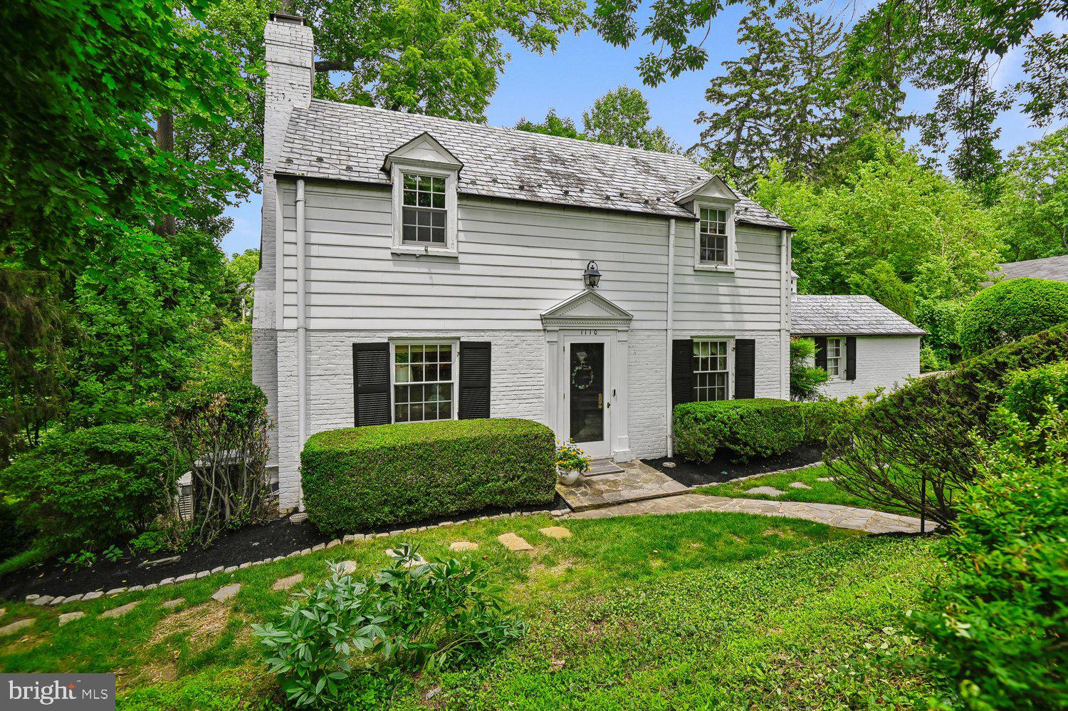 Set on a quiet, non-through street in highly desirable Poplar Hill — a secluded enclave between Roland Park and Mount Washington — this beautifully maintained 4-bedroom, 4.5-bath home offers timeless detail, generous living spaces, and room to grow into for decades to come. The main level is built for both everyday life and entertaining, with a formal living room anchored by a wood-burning fireplace and built-in cabinetry, a formal dining room, and a sunroom overlooking the backyard. The open kitchen features a breakfast bar and a casual dining space, a wet bar, and a large pantry, and it opens onto a full-sized deck made for hosting, plus a lovely patio just off the deck for quieter morning coffee or evening relaxation. The lower level adds a spacious family room with walk-out access to a brick patio, giving the home multiple distinct gathering spaces for family and guests alike. Upstairs, the primary suite includes a separate sitting room, generous closet space, and an en suite bath; the second bedroom also has its own en suite. The third bedroom has access to a walk-up attic for storage, while the lower level offers a fourth bedroom, a home office, a full bath, and separate laundry and storage rooms. Outside, the large lot is lush and tree-lined, offering exceptional privacy, with a flat, spacious backyard bordered by two gentle streams— perfect for playing, gardening, or simply spreading out.  A Generac whole-house generator provides peace of mind.  Poplar Hill offers a rare combination of privacy and convenience: you're walkable to Lake Roland and Mount Washington Mill and Village,  with Whole Foods, Starbucks, and Corner Pantry steps away.  I-83 is minutes away, with easy access to downtown Baltimore. It's the kind of home a family can settle into and call theirs for 30 years or more.