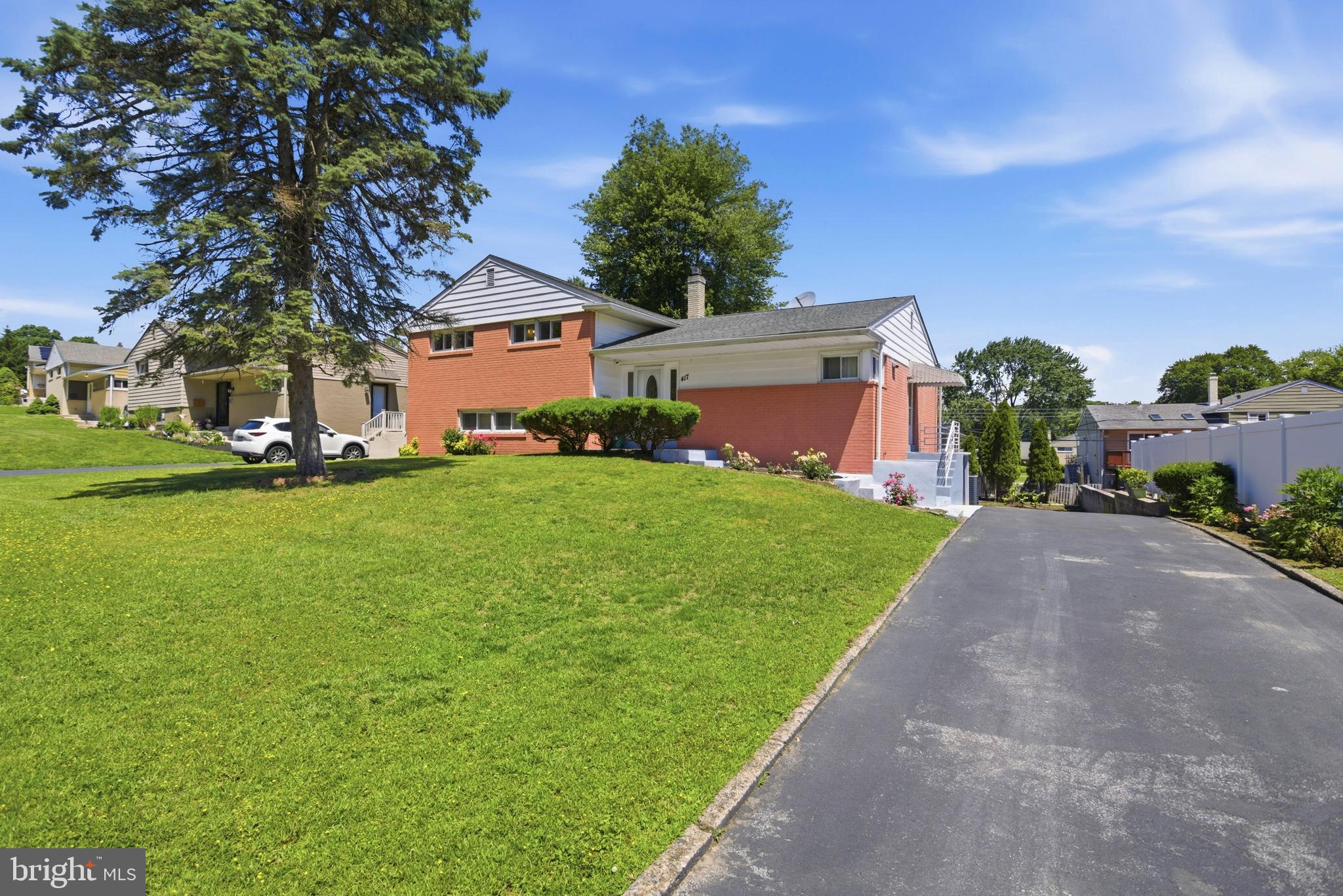 Exceptional opportunity in one of Springfield's most desirable neighborhoods! Offering over 2,300 square feet of living space, a rare in-law suite setup, 4 bedrooms, 3 full bathrooms, a 2-car attached garage, and a huge driveway with parking for several vehicles, 417 Foster Drive delivers the flexibility today's buyers are searching for. Whether you're accommodating multigenerational living, creating private guest quarters, or simply looking for extra space to spread out, this home offers options that are hard to find in Springfield Township. First Floor: A welcoming and functional layout featuring spacious living and dining areas, a well-appointed eat-in kitchen. Second Floor: Three generously sized bedrooms, including the primary suite. Lower Level: The true standout feature of this home. The finished lower level offers a complete in-law suite setup featuring a private bedroom, full bathroom, sitting room, kitchenette, and additional storage space. Whether used for extended family, long-term guests, a home office setup, or flexible living arrangements, this space creates possibilities rarely available in competing homes. Exterior: Situated on a generously sized lot, 417 Foster offers plenty of outdoor space to enjoy. The large driveway & attached 2-car garage adds even more convenience for homeowners and guests alike. Location is a major part of the appeal. Veterans Memorial Park is located directly within the neighborhood, while Halderman Field is just down the street. Enjoy easy access to Saxer Ave and local favorites including Dom & Mia's, Thunderbird Pizza, Saxer’s Pub, Vera's Water Ice, and Napoletano Bros. Minutes to Rt1, I-476, Philadelphia, and the Main Line.  Property is Being Sold As -Is. Don't miss this great opportunity!