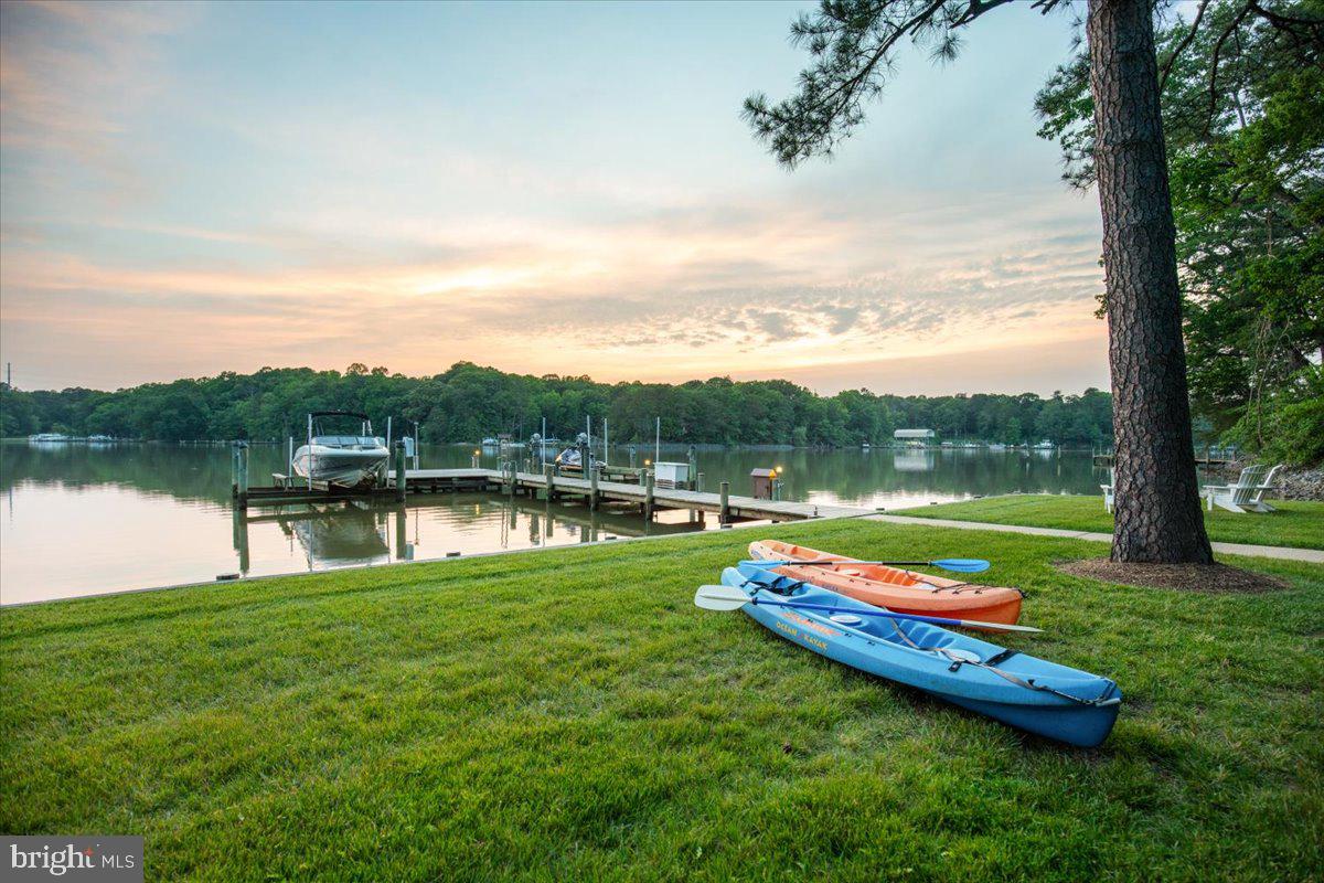 **PERRY POINT ON ST. LEONARD CREEK:** A premier 6.4-acre deep-water sanctuary along the shoreline of St. Leonard Creek. The property is incredibly private, offering placid and protected water. Wildlife is abundant with bald eagles, osprey, herons, and more. Located just an hour from Capitol Hill, the 4,300 SF contemporary-coastal home offers the ultimate year-round Chesapeake lifestyle. Enjoy four-season scenery plus boating, fishing, and crabbing right off the private pier, which features two 12,500 lb boat lifts. This section of St. Leonard Creek is perfect for water sports in the cove without the activity of the larger creek. Inside, a dramatic two-story glass wall showcases commanding water views. The house has a rich exterior with natural stone and copper guttering, downspouts. The interior has just been painted throughout, and most of the flooring is wide-plank white oak hardwood and slate. The kitchen in this open-concept plan is a chef's dream with custom cabinets and water views from every angle. Retreat to the upper-level owner's suite, where mahogany doors open to more wide-plank white oak floors and a deluxe spa bath with heated flooring...not to mentionh spectacular creek and property views! Guests will enjoy the three additional bedrooms and the legendary “Perry Point Ale House” on the lower level, featuring a 4-tap kegerator, ice machine, and a retractable HD cinema screen for game nights. Outdoor living is unmatched, featuring an expansive, one-of-a-kind bulkheaded flat lawn at the water’s edge—the perfect stage for crab feasts, tent parties, and sunset cocktails. The sale includes a Polaris Ranger 4x4 ATV and a massive live-edge California redwood table for 10. There is a second private well and electric for the waterfront improvements. All major inspections (well, septic, UST, WDI) already passed and certified in fall of 2025 and this home is ready for closing.