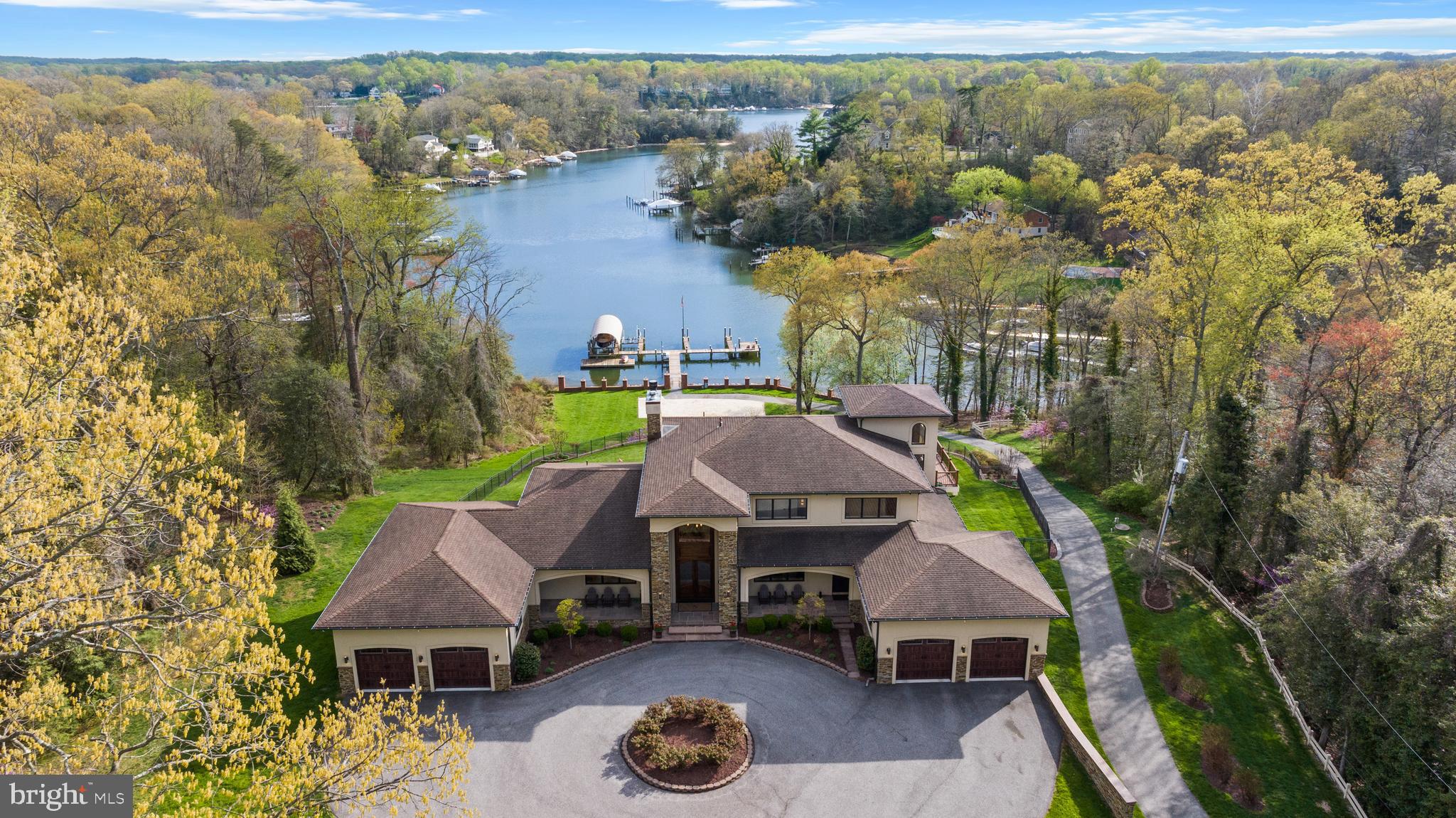 Welcome to this fabulous waterfront estate historically known as The POD.  Set behind the gates of an extraordinary 7+ acre waterfront compound, The POD offers a rare blend of privacy, scale, and resort-caliber living along Forked Creek and the Severn River.  Beautifully constructed and thoughtfully curated, the property unfolds as a true lifestyle destination, where every detail has been designed to elevate both everyday living and grand entertaining. 

A long, illuminated drive framed by mature crape myrtles leads to expansive, meticulously landscaped grounds. Outdoor living takes center stage with sweeping wraparound decks, multiple gathering spaces, and a heated saltwater pool surrounded by travertine stone, gazebo, and fire features. An outdoor kitchen, complete with EVO grill, gas burners, refrigeration, and bar seating, creates the perfect setting for waterfront entertaining, while the year-round spa and low-maintenance turf with putting green enhance the ease of ownership.

The private pier is a standout, offering multiple slips, lifts, floating dock access, and approximately 10 feet of water depth. An exceptional experience that is ideal for boating enthusiasts seeking effortless access to the Severn River and beyond. 

Inside, the main residence spans approximately 8,000 square feet, where refined finishes and architectural details are complemented by a light-filled, flowing layout. A grand foyer introduces the home, leading to elegant living and dining spaces, a chef’s kitchen equipped with premium appliances, and a welcoming sunroom overlooking the pool and waterfront. The main level Primary suite with private balcony, fireplace and spa-like bath is the perfect retreat after a day in the pool or on the water. A conveniently located elevator provides seamless access to all 3 levels. 

Designed for both relaxation and recreation, the lower level transforms into a true entertainment hub, featuring a nightclub-inspired lounge with full bar, a state-of-the-art theater, and dedicated fitness and recreation spaces. Head upstairs where an additional 3 bedrooms, 2 baths and an awe-inspiring office with wrap around deck offer comfort and flexibility for family and guests. A separate guest house offers additional accommodations with its own kitchen, living spaces, 3 bedrooms 2 baths and private comforts, an ideal retreat for extended stays or hosting with ease.

Advanced infrastructure and smart home technology, including whole-house automation, security, generator, and climate systems, ensure modern convenience is fully integrated into this exceptional offering.

The POD is more than a home, it is a private waterfront retreat designed for those who value space, privacy, and a seamless connection to the water. A truly resort-inspired setting, this property offers an unparalleled opportunity to experience the waterfront lifestyle in its most complete and effortless form. Welcome Home!