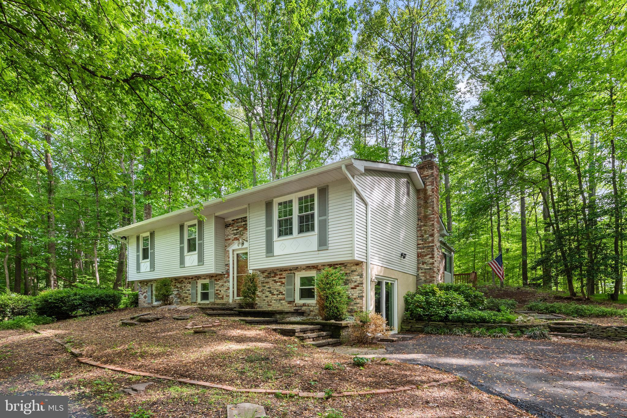 Gorgeous split level inside sought after Shenandoah Woods neighborhood with NO HOA on over 2 private and wooded acres of bliss. Updates galore - Home freshly painted from top to bottom including kitchen cabinets, Brand  new gutters, Complete kitchen remodel w/black SS appliances and granite 2019, Water heater replaced 2020, Water Filtration System, Hardwood Floors on main level, Carpet installed in 2020. Inside on the main level you have a very modern kitchen with cabinets white as snow, stunning granite countertops and island, luxurious backsplash, recessed lights , beautiful tile floors and plenty of sunlight coming in through the windows and the large sliding glass door. You will also discover the serene hardwood floors in the family room and hallway along with the primary bedrooms with it's own primary bath, two more bedrooms and another hallway full bath. On the lower level you have a spacious rec room, one bedroom, full bath and plenty of space for storage. As you walk outside from the kitchen you have your very own oversized sunroom which leads to the deck and patio which allows you to entertain indoor and outdoor, a true delight. There is also a huge shed outside for storage for all your gardening equipment or anything else you wish to store in it. Do not let this opportunity slip through your fingers!!