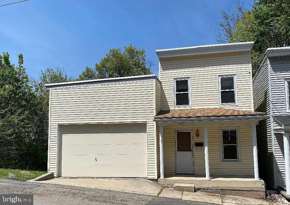 If you need garage space look no further. This quaint little single family home In Bunker Hill has an attached oversize garage at the end of the street. This home has the kitchen and living room on the first floor with 2 bedrooms and a full bath on the second. The lower level  has a bonus room that can  be used as another bedroom, office, or extra living space.  It has a walk out door to the rear that open to a spacious deck with a yard. The attached oversize garage offers plenty of storage and workshop space. It has an area with toilet and deep sink to serve as an additional half bath.