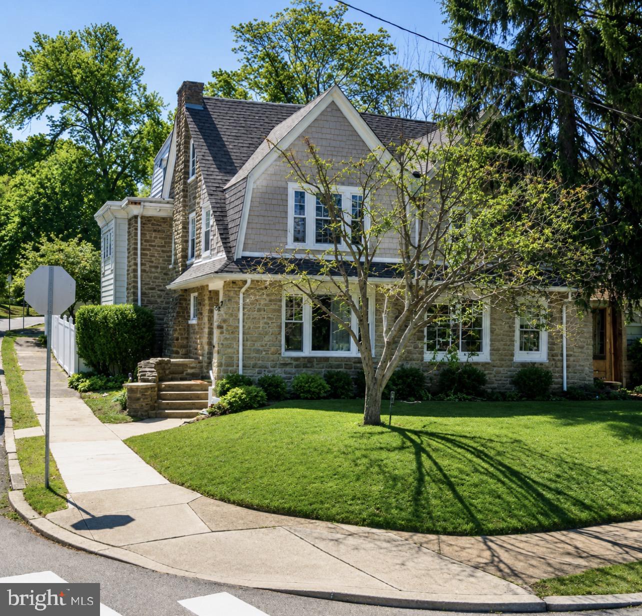 Welcome to 7031 Lincoln Drive, a large and well-maintained home located in the highly desirable West Mt. Airy neighborhood of Philadelphia. Entering from Rosemary Lane, you’re immediately welcomed by a bright sitting area where oversized front windows flood the main level with natural light. The spacious living room features a beautiful stone mantel, creating a warm and inviting atmosphere perfect for relaxing or entertaining.

Continuing through the home, you’ll find a formal dining room and an eat-in kitchen with direct access to the backyard oasis. The exterior space is complete with a privacy fence, front, side, and rear yard areas, plus a detached two-car garage conveniently located just steps from the back entrance.

The second floor offers three generously sized bedrooms, including one exceptionally large room, all filled with abundant natural light. A full hall bathroom completes this level. The third floor provides two additional bedrooms and a second full bathroom, offering flexibility for larger households, guests, home offices, or hobby spaces.

The home is carpeted throughout, creating a comfortable and cozy feel, while still offering the opportunity to easily expose or replace flooring to suit your personal style. The basement level features a laundry area, excellent ceiling height, walk-out stairs, and freshly cemented flooring—an ideal setup for future finishing or additional living space.

Perfectly situated near parks, trails, public transportation, dining, and entertainment, this home also offers quick and easy access to Center City via Lincoln Drive. If you’ve been searching for a spacious property in one of Northwest Philadelphia’s most sought-after neighborhoods, this is a must-see opportunity. Schedule your showing today!