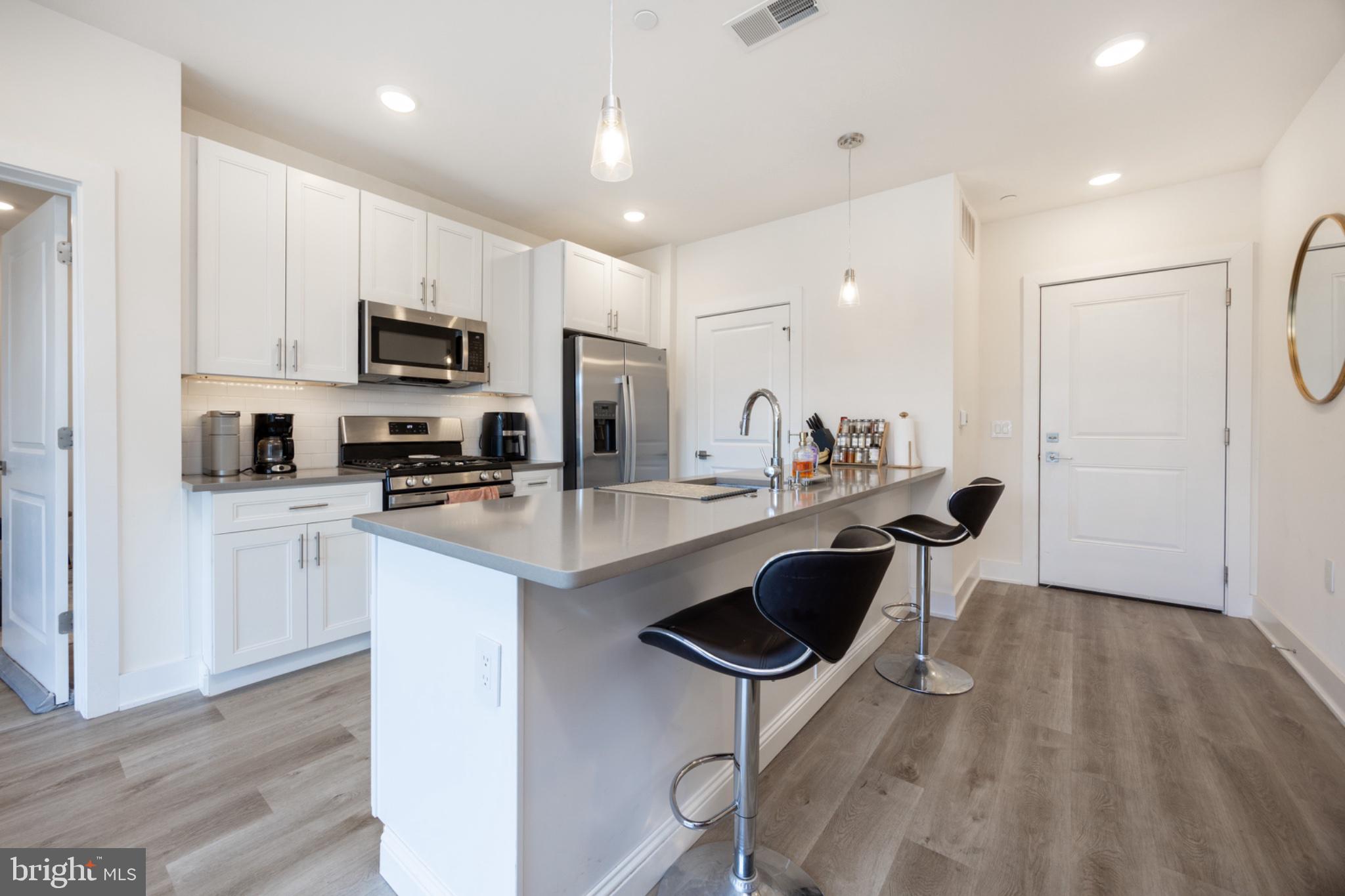 Step inside this beautifully maintained flat-style condo in the sought-after North Liberty Triangle community, located in Philadelphia’s vibrant Northern Liberties neighborhood. This 2-bedroom, 2 full bath home features a bright, open-concept living and kitchen area designed for both everyday living and effortless entertaining. The modern kitchen offers ample cabinetry, quartz countertops, and sleek finishes that flow seamlessly into the spacious living area. Enjoy abundant natural light from oversized windows, highlighting the home’s airy feel and contemporary design. Both bedrooms are generously sized, including a comfortable primary suite with a walk-in closet, and the convenience of in-unit laundry adds to the ease of living. Step outside to your private, spacious balcony perfect for relaxing or enjoying your morning coffee. Community amenities include a beautifully landscaped courtyard, on-site fitness center, and an underground parking garage. Ideally situated just steps from Northern Liberties’ popular restaurants, cafes, shops, and nightlife, this home offers the perfect blend of comfort, convenience, and city living.