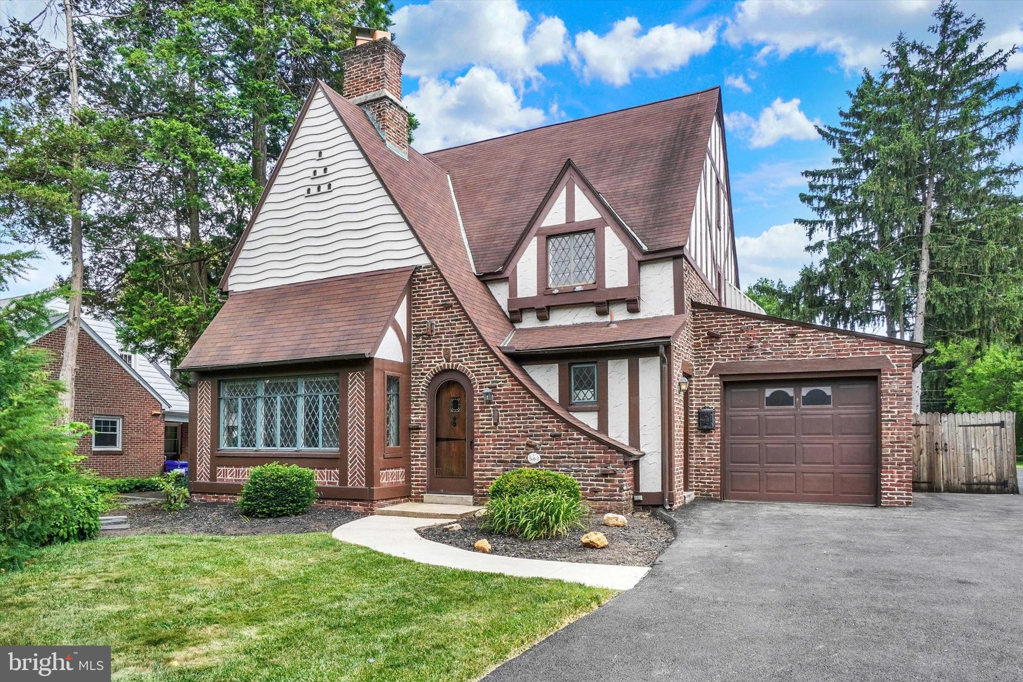 Welcome to 306 Elmwood Blvd, a stunning Tudor Revival home nestled in the heart of York Suburban School District's historic Elmwood neighborhood. Rich in 19th-century charm and timeless architectural character, this beautiful residence offers over 2,300 square feet of living space, featuring 4 bedrooms, 2.5 bathrooms, and 3 dedicated garage spaces. Step inside the inviting foyer and immediately appreciate the craftsmanship and warmth throughout. The formal living room showcases hardwood floors, recessed lighting, a gas fireplace, and an abundance of natural light from the surrounding windows. The spacious formal dining room is perfect for entertaining and is accented by chair rail molding, crown molding, and a beautiful built-in display cabinet. The kitchen offers an open layout and convenient access to the adjacent butler's pantry, providing additional storage and functionality. The home's elegant spiral staircase leads to the second floor, where you'll find the primary bedroom complete with a walk-in closet, along with two additional bedrooms and a full bathroom. The uppermost level features a generously sized fourth bedroom with its own private en-suite bathroom, creating an ideal guest suite, home office, or private retreat. The outdoor living spaces are just as impressive. Enjoy a fully fenced backyard highlighted by a large 28' x 20' deck, basketball hoop, and a gorgeous in-ground pool with plenty of space for relaxing and entertaining. A spacious driveway provides ample off-street parking both inside and outside the gated area, in addition to the home's three garage spaces. Opportunities to own a home of this character, style, and setting are rare. Schedule your private showing today and experience everything this one-of-a-kind Elmwood gem has to offer.