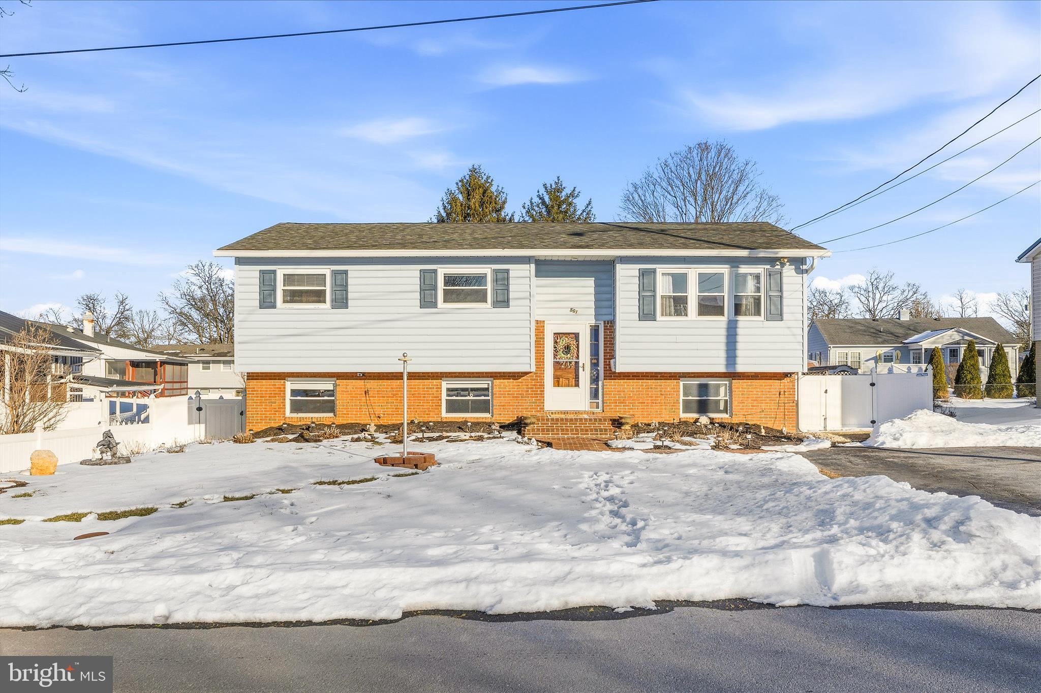 Welcome to 501 Cara Court in Martinsburg, WV, a beautifully maintained split-level home offering space, flexibility, and long-term peace of mind.

Built in 1969 and thoughtfully updated over the years, this 4-bedroom, 3-bath home provides a layout that works perfectly for multi-generational living, guest space for entertaining, or simply room to spread out.

The entire interior has been professionally painted in 2025, all interior doors were replaced, and brand-new LVP flooring was installed. Upstairs, you’ll find three spacious bedrooms (each with double-door closets), two fully renovated bathrooms completed by Bath Fitters in 2024 with transferable lifetime warranties, and original hardwood floors preserved beneath the new flooring.

The kitchen features handmade cabinetry that has been freshly painted with updated hardware, and breakfast bar nook.

Downstairs offers even more flexibility with a very spacious private bedroom, full bathroom, recreation room with walk out access to the backyard, and laundry space with built-ins and abundant storage. Making this space ideal for extended family or private guest quarters.

Major system updates provide true peace of mind:
• HVAC (2023) with back up heat source of electric baseboard 
• Electric panel and wiring with emergency shutoff (2024)
• Hot water heater (2024)
• Water softener (2019)
• Gutters with transferable Leaf Filter lifetime warranty (2024)
• Transferable Choice Home Warranty paid through July 2026

Step outside and enjoy your own private backyard retreat. The saltwater pool system was updated in 2021, with additional pool equipment upgrades in 2024 and 2025. The fully fenced yard, sunroom addition, firepit area, sheds, and included outdoor furniture make this home ready for entertaining from day one. Even the landscaping is filled with perennials that return each spring.

Conveniently located minutes from Berkeley Medical Center, I-81, War Memorial Park, Oatesdale Park, and the new pickleball courts, this neighborhood location checks all the boxes.

If you’ve been searching for a home with space, updates, and a backyard made for making memories, 501 Cara Court is ready to welcome you home.