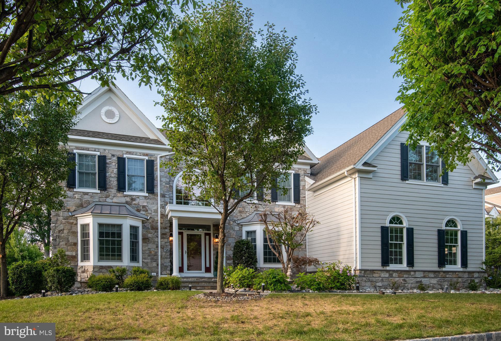 REFRESHED LUXURY on the Main Line! Price Reduced Plus primary bedroom/sitting room lightened with fresh paint/front trees professionally pruned. On a desirable, premium home site, this stately stone-front manor offers a seamless blend of timeless elegance; airy design plan; modern functionality, and exceptional lifestyle convenience. Enjoy picturesque, front-to-back green views and easy walkability to the community pavilion, park/ponds, fitness center, recreation barn, trail, pool, and sport courts in the legendary enclave, Liseter. A grand, sunlit, two-story foyer with a sweeping staircase creates a commanding first impression, then opens to refined living and dining rooms adorned with custom trim/molding, ceiling treatments, and walk-in bay windows that capture brilliant natural light. Softly gleaming, easy-care, wood flooring, found in much of the home, reflects the luminous life spaces of this well-windowed interior. Designed for everyday living and entertainment, the open-floor plan unfolds into a stunning two-story great room/fireplace filled with an ethereal, light-drenched ambiance, and the adjacent chef’s kitchen, featuring stainless steel appliances, rich granite countertops, large center island with seating, custom tile backsplash, under-cabinet lighting, built-in desk station, and 2 step-in pantries. A harmonious, integrated breakfast area and vaulted sunroom/morning lounge create a seamless indoor-outdoor flow to the expansive composite deck and screened gazebo—imagine effortless hosting or lazy day relaxation in this easy, intuitive layout. Easily work from home in the private study with custom built-in work centers. Exquisite PR , secondary stairs, well-planned mudroom w/roomy closet, spacious laundry w/tub/cabinetry/outside entrance complete this floor. Upstairs, a wide hall, highlighted by the refined aesthetic of espresso toned wood flooring and sophisticated iron staircase, leads to four generously sized bedrooms. A luxurious, wood-floored primary suite boasts a sitting room, 3 custom-shelved walk-in closets, dedicated vanity alcove/dressing station, and spa-inspired primary bath w/serene soaking tub, double vanity, glass-enclosed shower, custom tile, and private water closet. Bedroom four features a well-endowed walk-in closet and en-suite bathroom, while bedrooms two and three access a well-appointed third full bath. Ready-to-finish, walk-out lower level with glass door, two full-size windows, and bath plumbing rough-ins, is primed for your creative expansion of living area with your perfect personal design desires. There is also plentiful storage and mechanical utility access including manabloc direct run plumbing center. The immaculate 3 car garage awaits your pampered autos with epoxied floors and storage loft. This is a rare opportunity to join one of the Main Lines’s most desirable communities—offering not just an immaculate residence, but the sought-after “Liseter” lifestyle with residents enjoying exceptional resort-like living amid beautifully maintained grounds with two ponds and hundreds of acres of preserved open space. Amenities include an entrancing infinity-edge pool, superbly appointed clubhouse w/fitness center/yoga studio, tennis/pickleball courts, basketball court, scenic walking/running/biking trails, and inviting gathering places like the splendid timber-framed party barn and pleasant open-air pavilion. Liseter’s vibrant, community-oriented atmosphere provides a full calendar of events including outdoor concerts, Oktoberfest celebrations, First Friday cocktail parties, food trucks, seasonal festivities—creating a true neighborhood experience. Moments away, Ellis Preserve features Whole Foods and a variety of restaurants and shops. With nearby Episcopal Academy, popular Marple Newtown school district, and easy access to Center City, Philadelphia International Airport, the train and transportation routes, 3805 Woodland Drive is your ultimate lifestyle sanctuary.