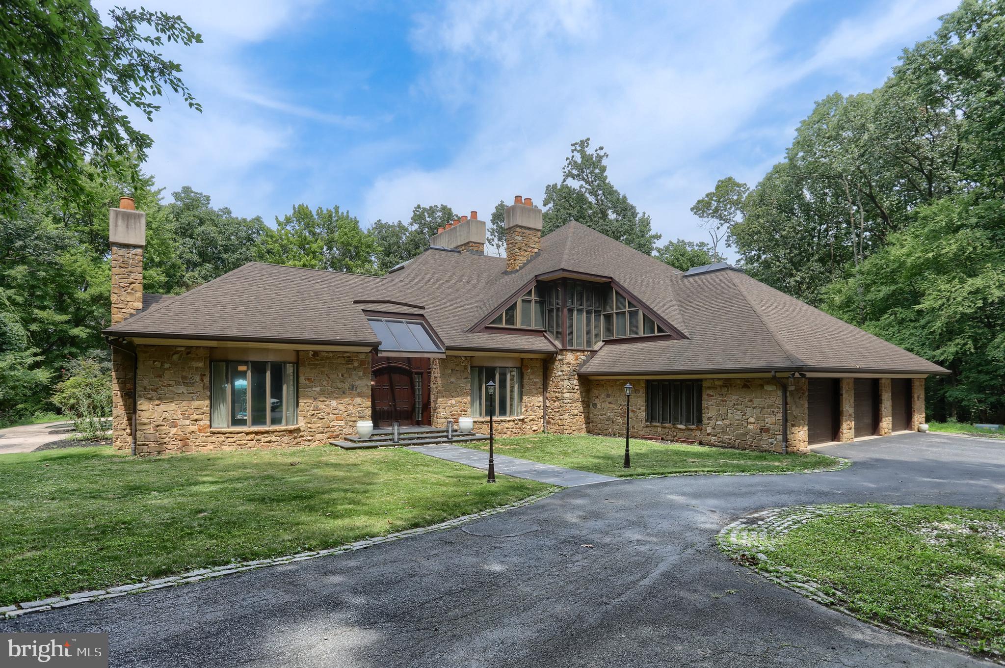 Welcome to Hershey. This custom home in Hillcrest feels like an English Manor home. It  is nestled on a 2.76 wooded lot in Derry Township.  The details will please the most discriminating buyer.  It has been beautifully maintained, brought back from it’s neglected state and now offers comfort, convenience, and a desirable location just minutes from downtown Hershey. The home boasts 6,463 square feet featuring 5 fireplaces, custom oversized moldings, natural light, large rooms, exquisite details, 3 car garage, wrap-around deck, and stamped concrete patio around a sparkling in-ground pool. The artisan quality craftsmanship blends with many extra features to create a unique and comfortable home. It offers generous bedrooms, comfortable gathering spaces, and outdoor areas perfect for relaxing, entertaining, or enjoying the seasons.

The setting is private, reached by a meandering lane that flows into a circular driveway.  The stone exterior is the first thing you see and is used as accents throughout the home.

The home is drenched in natural light. The first floor features a expansive foyer flanked with the formal living room and dining rooms, both boasting fireplaces and oversized moldings. The family room is exceptionally large and features a stone fireplace with stone accent wall and built-ins. The Chef’s kitchen features custom cabinetry, 6 burner cook top, Sub-zero refrigerator, double oven, separate griddle/grill and an extended island that will seat 7 comfortably.  The antique beams and custom Spanish Tile flawlessly maintain the integrity and ambiance of the interior design. The butler panty has vegetable sink, under counter refrigerator/freezer and custom cabinetry. Every chef will appreciate the huge walk-in pantry with an abundance of shelving for storage and the clever “grocery door”.  The Sun room features a corner stone fireplace with stone hearth. There are 3 sides of windows. Two sides fold open creating flow from each room to bring the outdoors in and allows access to the pool. The two decks and wraparound deck are a perfect areas to enjoy the wooded setting.  

The mid level features a library with 20’ ceilings and towering bookshelves with a slide ladder for easy access. There is a full bath and large room that could be a game area, exercise room, or even a bedroom suite.  The 2nd laundry is also on this level.


The bedroom level features the primary suite featuring a sitting area with a fireplace and a dressing area that is 2nd to none, 2 walk-in closets, 2 vanities and a separate luxurious bath.  The bath has been completely remodeled with soaking tub, glass shower and new vanities.  This level also has two additional bedrooms with lofts and their own toilets and vanity with a shared shower.  The closets, study areas and built-ins are incredible.  The windows and skylights ensure these rooms are always airy and bright. 

The outside area is special as well.  The kidney shaped in-ground, heated pool will provide hours of summer enjoyment. The pool has been redone as well as the upgraded decks to composite materials.  

The private location is minutes to downtown Hershey and major highways.  The 2.76 acres, extravagant space, elegant rooms and dramatic detailing offer luxury living with  a Manor Home feel.