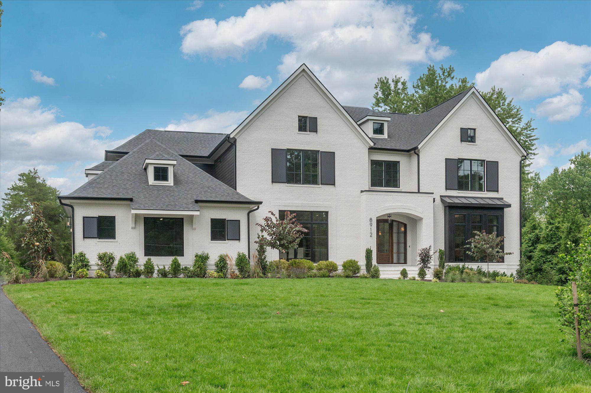 Cherry Hill Custom Homes presents 8912 Gallant Green Drive. This one of a kind property boasts 1.42 acres on a quiet street in Woodside Estates, and includes a pool and spa.  The gorgeous all-brick transitional design features 6 bedrooms, 6 full bathrooms, and three powder rooms with 8,594 square feet of finished living space over three levels, dual staircases, and an attached four car garage, and an elevator servicing all three floors. The main level includes 10ft ceilings, beautiful European White Oak wood floors, a gourmet kitchen with paneled Thermador appliances, quartz countertops, and frame-less custom cabinetry, a pantry with additional refrigerator, a main level guest suite, a breakfast nook and an elegant formal dining room. A great room with coffered ceiling and gas fireplace is flanked by a large screened porch with heaters and a fireplace with stone surround and a grilling deck. A private sitting room and a mudroom with  built-in cubbies complete the main level living spaces. The upper level is highlighted by a luxurious owner's suite with gas fireplace, walk-in closet with built-ins, a spa-like bathroom with heated floors, double vanities, stand-alone soaking tub, heavy glass enclosed shower and a private laundry room separate from the main laundry room. The lower level features a spacious rec room with wet bar and a gas fireplace with flanking built-ins, a separate powder room, an exercise room, and an additional bedroom with full bathroom. The in-ground pool and spa is the star of this spacious yard with over 400 feet of depth and a built-in irrigation system, with plenty of room for sport or tennis court.  The natural gas heated saltwater pool is 18'x38' and ranges in depth from 3.5' to 7' and the spa is 8'x8'. The pool features beautiful Tundra Grey Marble decking, underwater lights, automatic pool cover, deck mounted water jet fountains, and automated controls. Convenient to Tysons, McLean, Spring Hill Rec Center, and much more.