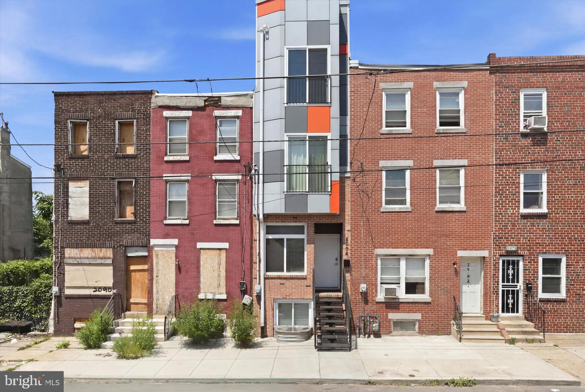 Welcome to 2044 N 5th Street, a newer build without the expensive price tag! This is an ideal property for savvy homebuyers or investors looking to capitalize on a rapidly appreciating 19122 zip code. Built in 2023, this 3-year old property offers a fantastic layout for roommates, families, couples, or individuals looking for low maintenance living, while sitting only minutes from the allures of East Kensington and Fishtown. Nestled on a wide street with parking on both sides, this home offers 3 bedrooms, 2.5 bathrooms, a fully finished lower level with powder room, a quaint backyard, dual (2) roof decks with skyline views, and the ongoing benefit of a tax abatement. Although narrow in stature, this home offers a TON of usable vertical square footage with a sensible layout that caters to growing families or roommates. Massive windows allow for tons of light to pour in past your juliet balconies on both front-facing bedrooms. The finished basement functions as a 4th bedroom, at-home office, or exercise area, with a full sized egress window offering amble below grade light. Only minutes from Norris Square Park, tons of residential development in every direction, and all the fantastic food and nightlife options of Fishtown, this property packs a serious punch! 2044 N 5th is ready for new owners.