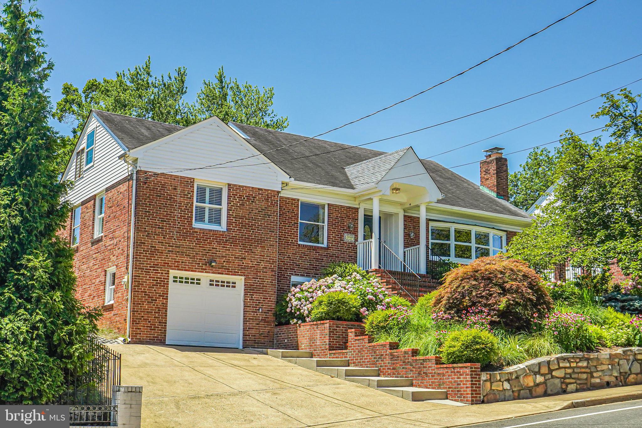 This is THE one you've been waiting for!

Welcome home to an elegant and light-filled single-family home in the iconic Maywood neighborhood of Arlington, VA. Offering 5 bedrooms and 4 full bathrooms, this home provides ample space that seamlessly combines both charm and modern luxury. Continuously updated and meticulously maintained, this home is ready to welcome its new owners.

There's so much to discover in this home. The main floor features a cozy gas fireplace (with remote) in the living room, which is perfect for chilly winter evenings. Come spring, you'll be dazzled by the beautiful blooming cherry tree. Other main level features include 3/4-inch hardwood floors, bay windows, recessed lighting, crown molding and built-in shelving.

The kitchen, as always, is the heart of the home and this expansive kitchen provides a great place to gather with family and friends. Cooks in the family will delight in plenty of countertops for prepping meals and cabinets for storing all those cooking gadgets. The stainless-steel refrigerator with French doors, the stove and built-in microwave are Frigidaire Gallery complemented by a Bosch dishwasher. The kitchen has a breakfast area, a door to the garden, as well as an island with seating for three.

Additionally, the main floor has a separate dining room, study, full guest bathroom, and two large bedrooms with ample closet space. One bedroom also features an ensuite bathroom with marble finishes. A welcoming foyer, plus linen and coat closets complete the main level.

The spacious primary bedroom on the upper level has a sitting area, French doors that lead to a composite deck for enjoying morning coffee, and a walk-in closet with an Elfa® system. The ensuite bathroom has a marble countertop, ceramic flooring, luxurious Restoration Hardware fixtures and a large shower with built-in niche.

Also on the upper level is a loft style bedroom which can serve as an office, reading room, or bedroom. The long hallway to the bedroom offers lots of additional storage in the eaves.

Continuing to the lower level, step into the recently renovated, inviting bedroom with a coffered ceiling, LVP flooring, and charming window. There's a full bath adjacent to the bedroom as well as a spacious rec room and office area. As in other parts of the house, there is plenty of organized closet storage on this level, too. The separate laundry area/mud room has an exit directly to the completely renovated garage.

The custom garage renovation in 2023, at a cost of $20K, provides an updated electric panel, 2 large windows for lots of light, and is an organizer’s dream, with four sets of gloss-front cabinets, a butcher block counter, and a slat wall system for sports equipment, tools, etc. The garage floor features high end SwissTrax flooring.

Fully fenced and professionally landscaped with plantings as well as a lawn, a backyard oasis awaits! Enjoy entertaining on the covered flagstone patio or play a game of basketball on the sports court. In addition to the 1-car garage, the electronic gate leads to the parking pad which allows for two to three secure parking spaces.

Located on renowned Lorcom Lane, this home provides convenient access to Arlington and DC's vibrant dining and cultural experiences (one traffic light to DC!). National Airport (DCA) is 15 minutes away and the Pentagon is 7 minutes. Surrounded by parks including Woodmont Park, Thrifton Hill Park, the Maywood Mini-Park, historic Fort CF Smith, and within the Donaldson Run Community Pool zone (membership required). Bikers, runners and walkers will all love easy access to the Custis Trail which leads to both the W&OD Trail as well as the Mount Vernon Trail. It's truly a perfect blend of urban luxury and accessibility.